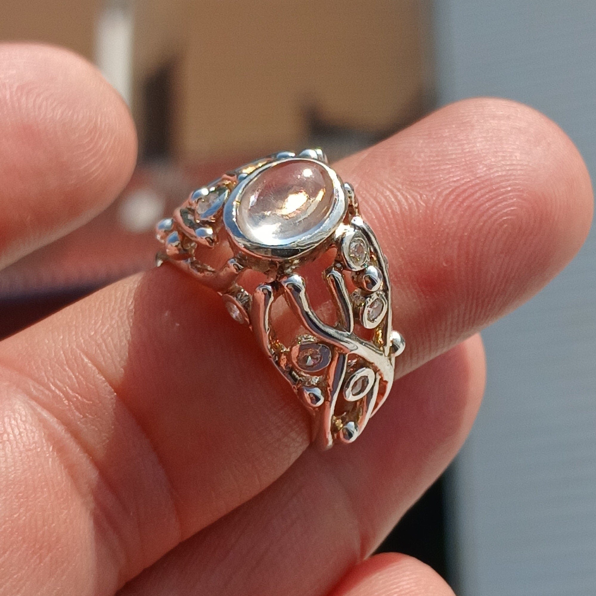 A polished sterling silver ring featuring an oval moonstone, showcasing its elegant design and high-quality craftsmanship.