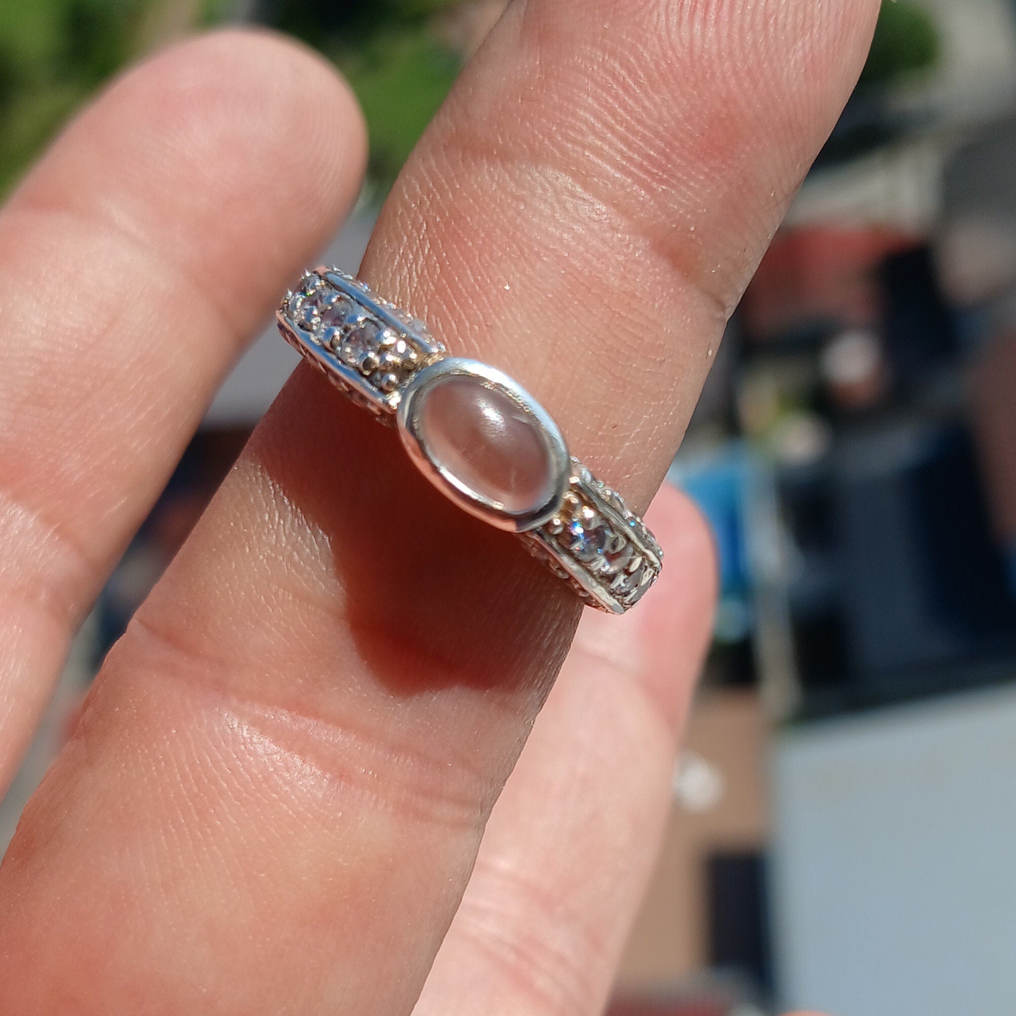 A polished sterling silver ring featuring an oval moonstone, hallmarked 925, showcasing its elegant design.