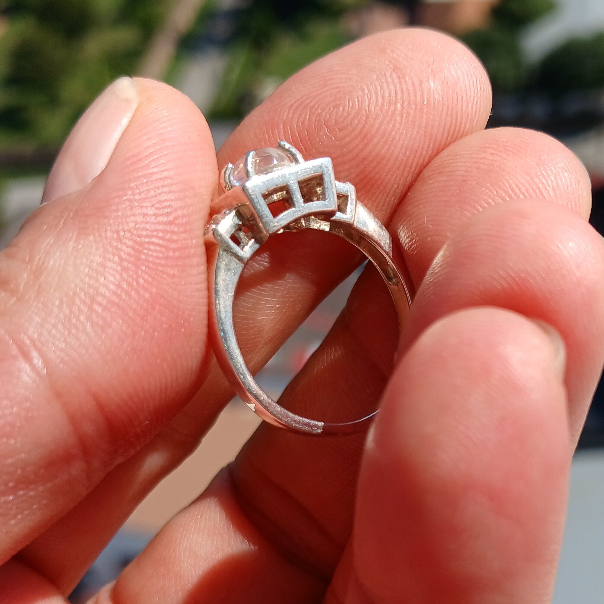 A beautifully polished sterling silver ring featuring an oval moonstone, showcasing a square-shaped design and hallmarked 925.