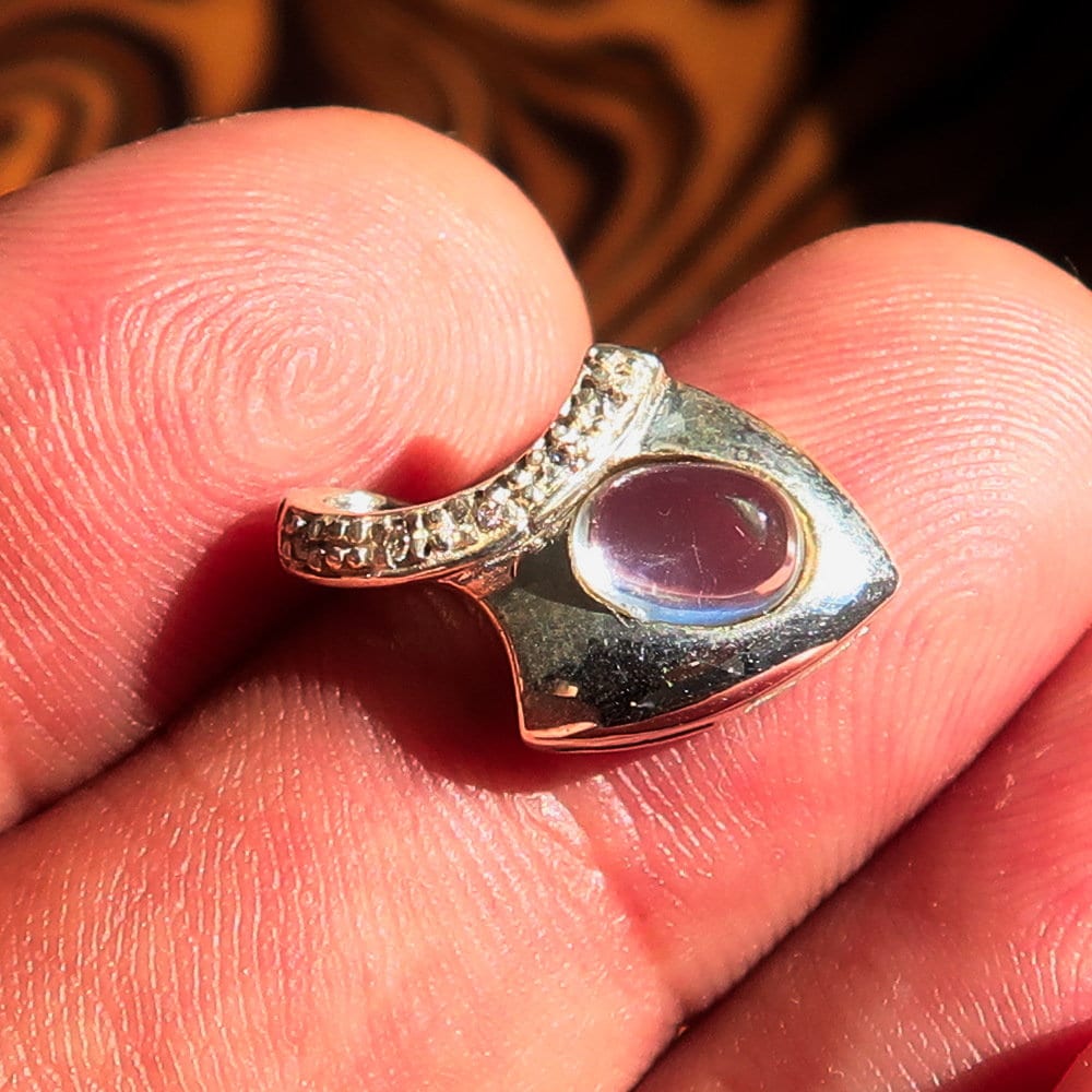 A stunning Moonstone Silver Pendant featuring an oval Ceylon Moonstone surrounded by sparkling Cubic Zirconias, crafted from high-quality sterling silver.