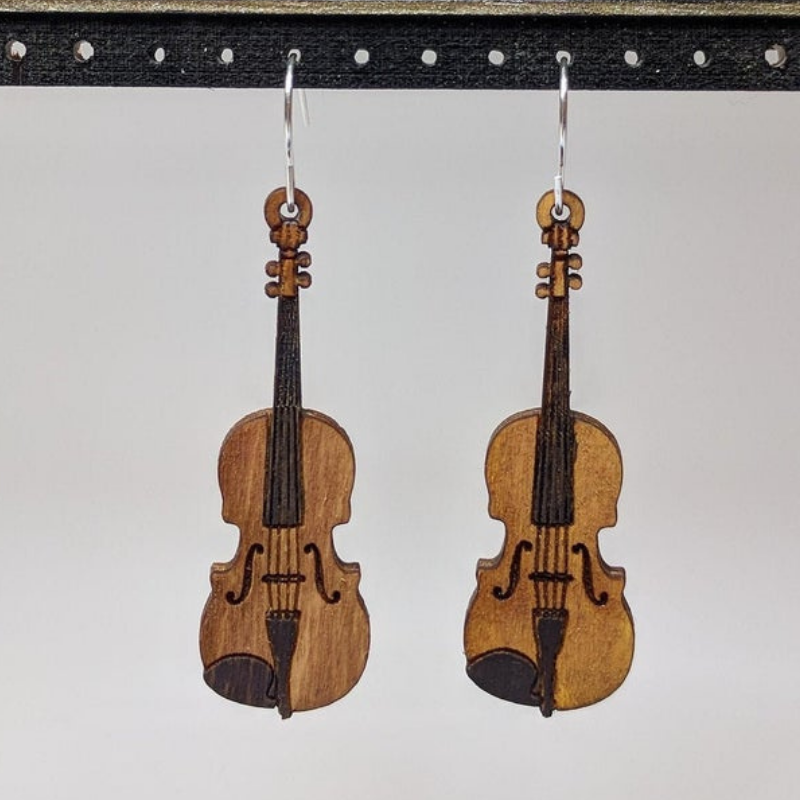 A pair of Musical Instruments Natural Wood Earrings featuring miniature wooden instruments like guitars and drums, crafted from lightweight Birchwood.