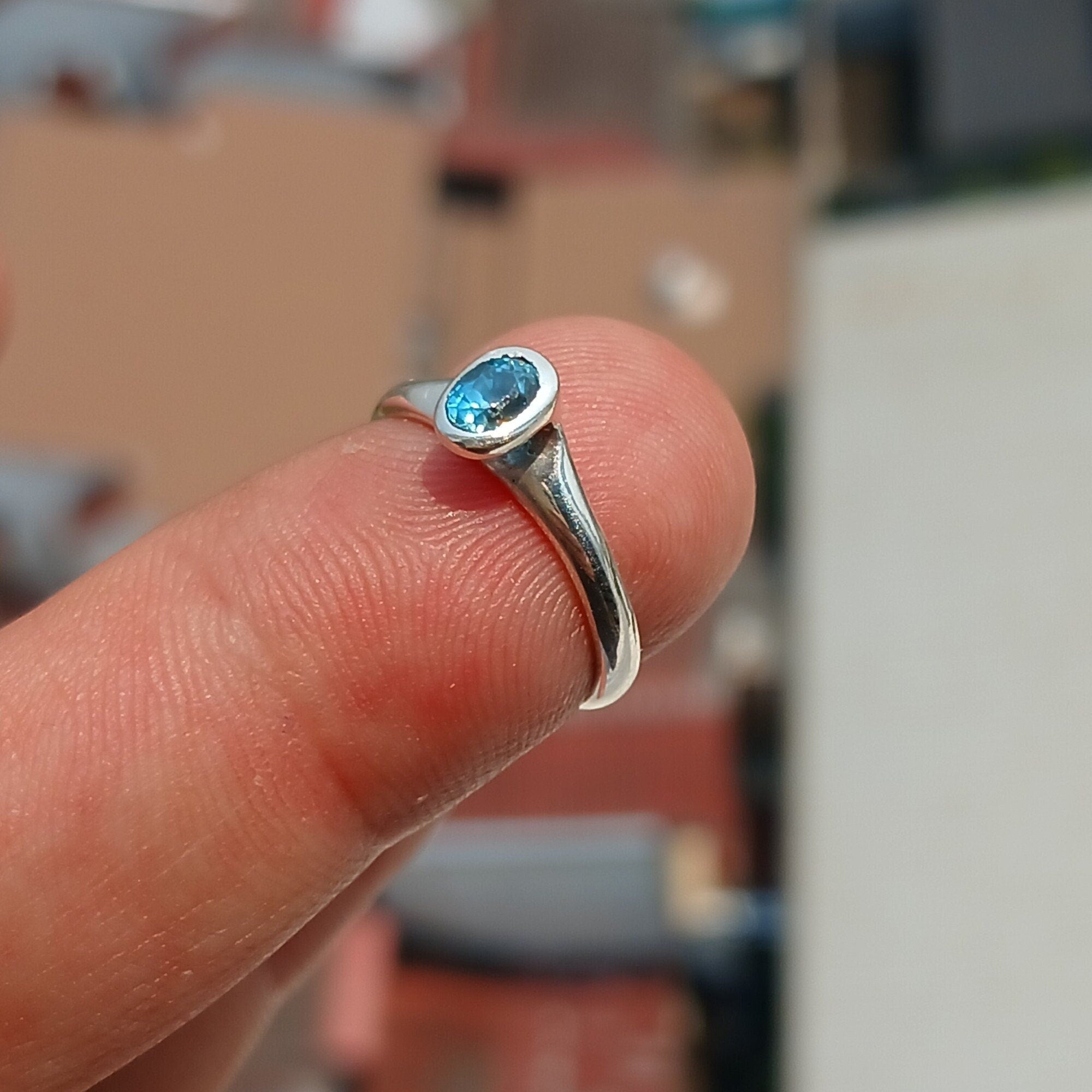 Natural Blue Zircon Ring in polished sterling silver, featuring an oval cut blue zircon gemstone, hallmarked 925.