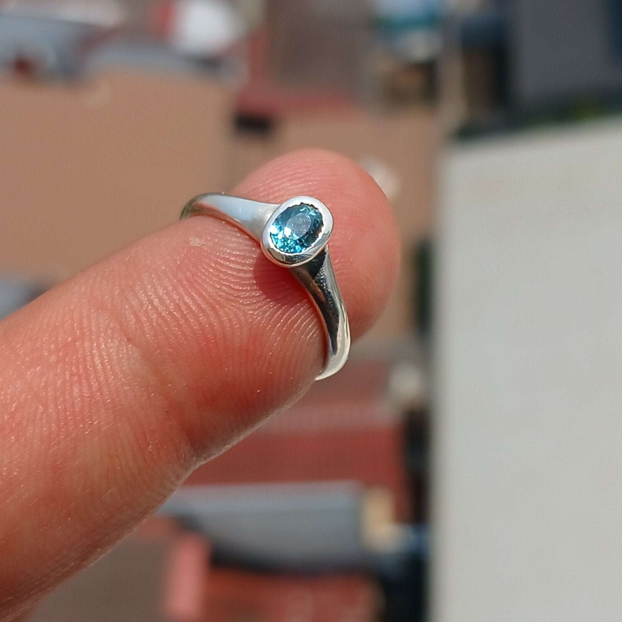 Natural Blue Zircon Ring in polished sterling silver, featuring an oval cut blue zircon gemstone, hallmarked 925.
