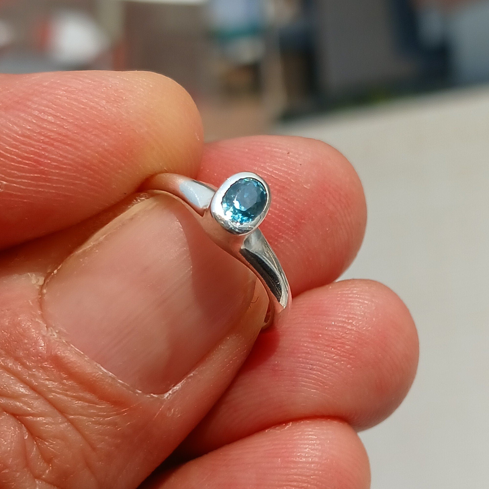 Natural Blue Zircon Ring in polished sterling silver, featuring an oval cut blue zircon gemstone, hallmarked 925.