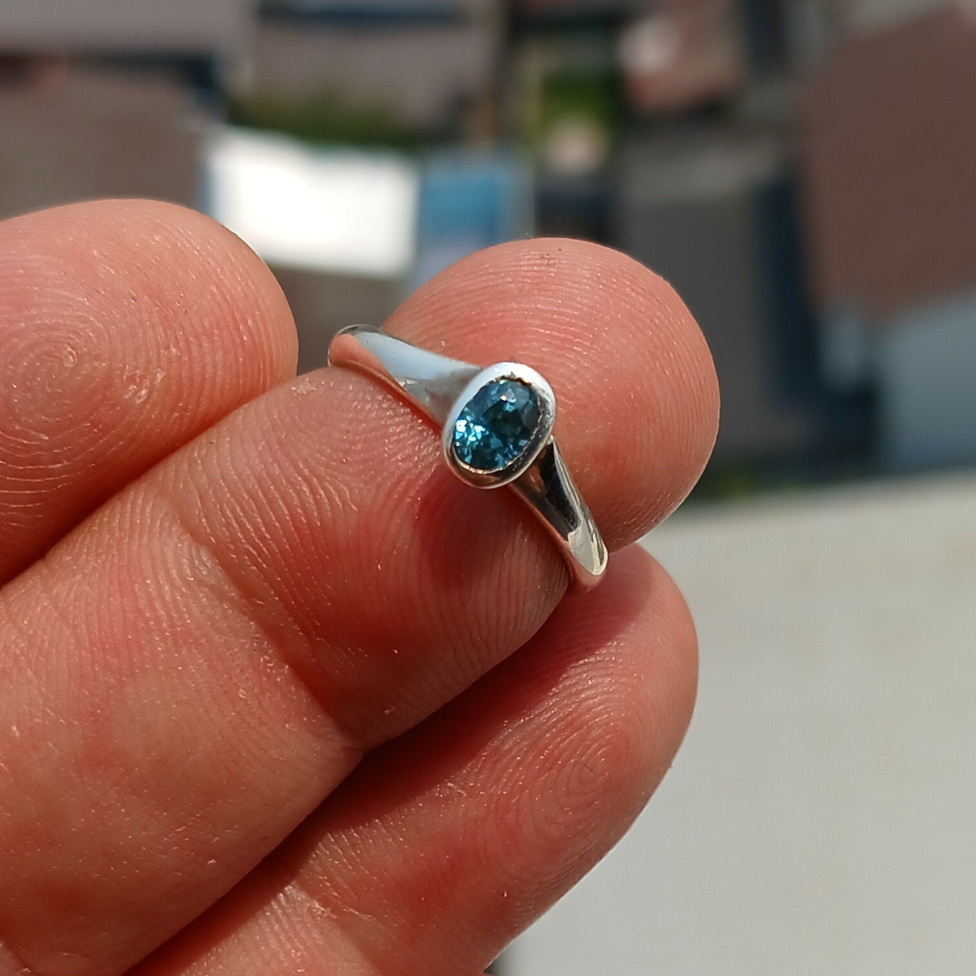 Natural Blue Zircon Ring in polished sterling silver, featuring an oval cut blue zircon gemstone, hallmarked 925.