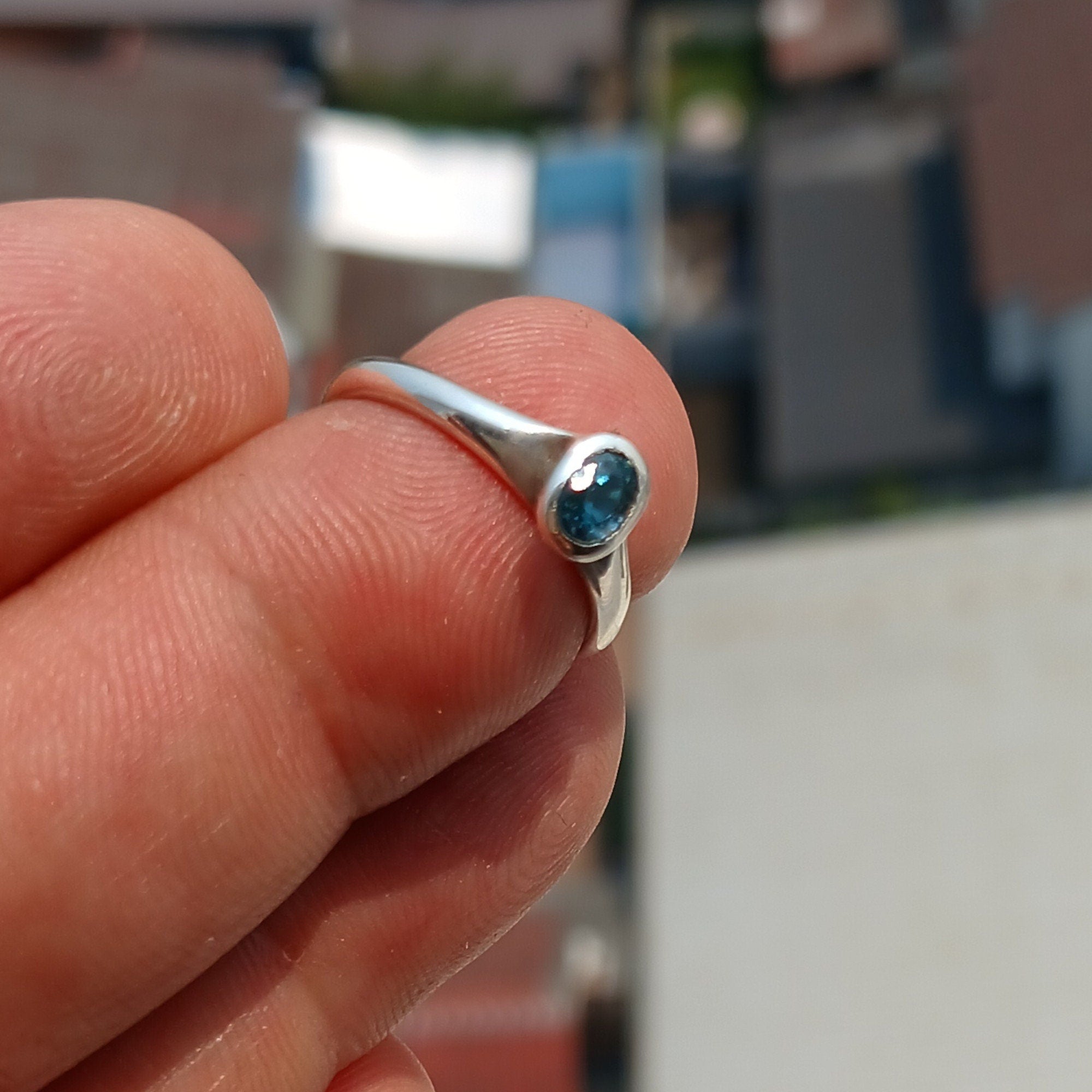 Natural Blue Zircon Ring in polished sterling silver, featuring an oval cut blue zircon gemstone, hallmarked 925.