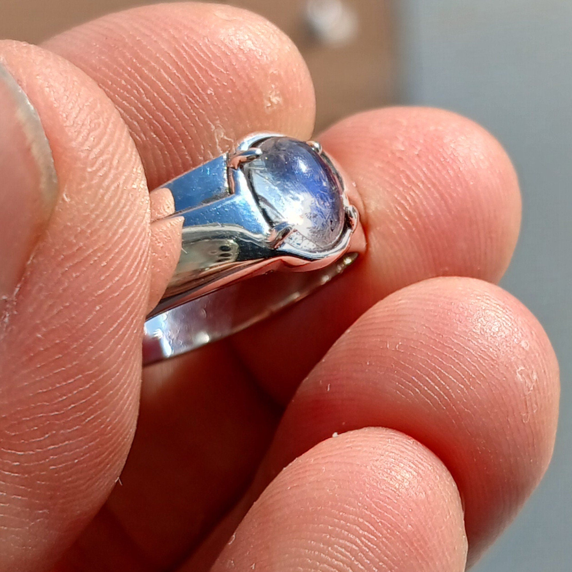 Natural Moonstone Ring featuring an oval Ceylon Moonstone set in polished sterling silver, showcasing its elegant solitaire design.