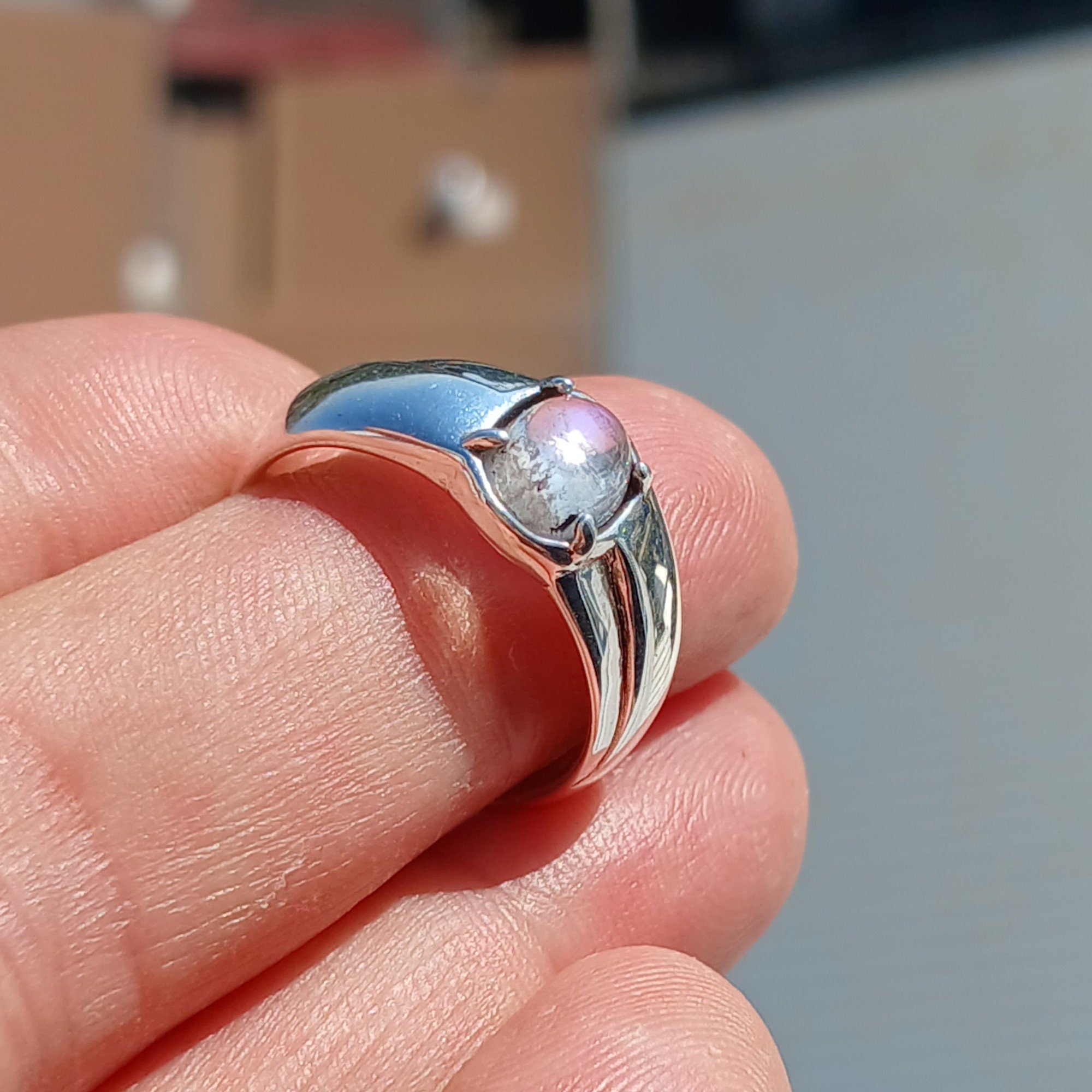 Natural Moonstone Ring featuring an oval Ceylon Moonstone set in polished sterling silver, showcasing its elegant solitaire design.