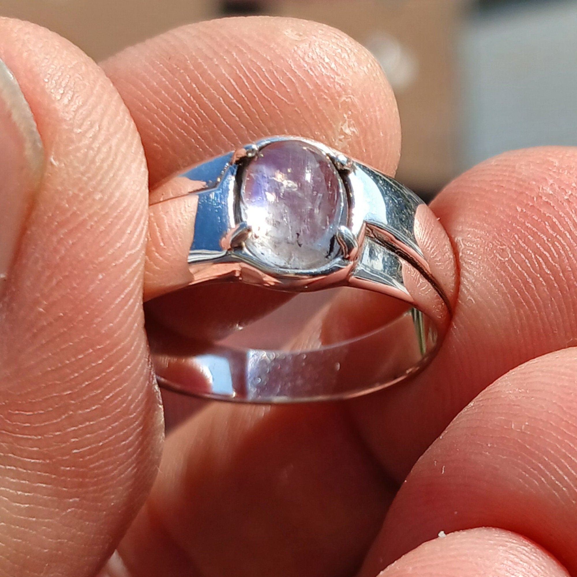 Natural Moonstone Ring featuring an oval Ceylon Moonstone set in polished sterling silver, showcasing its elegant solitaire design.