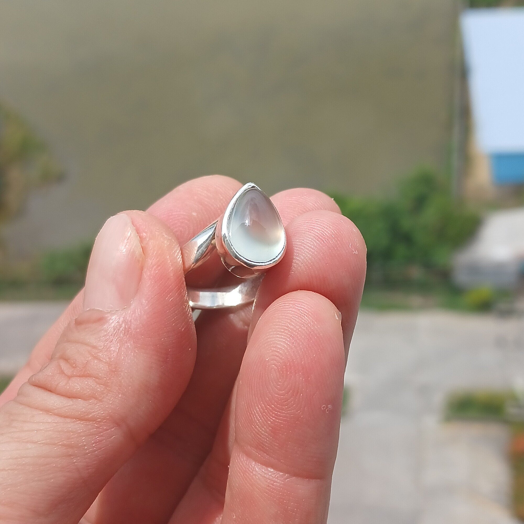 Natural Prehnite Ring featuring a pear-shaped green gemstone set in a polished sterling silver band, showcasing elegance and quality craftsmanship.