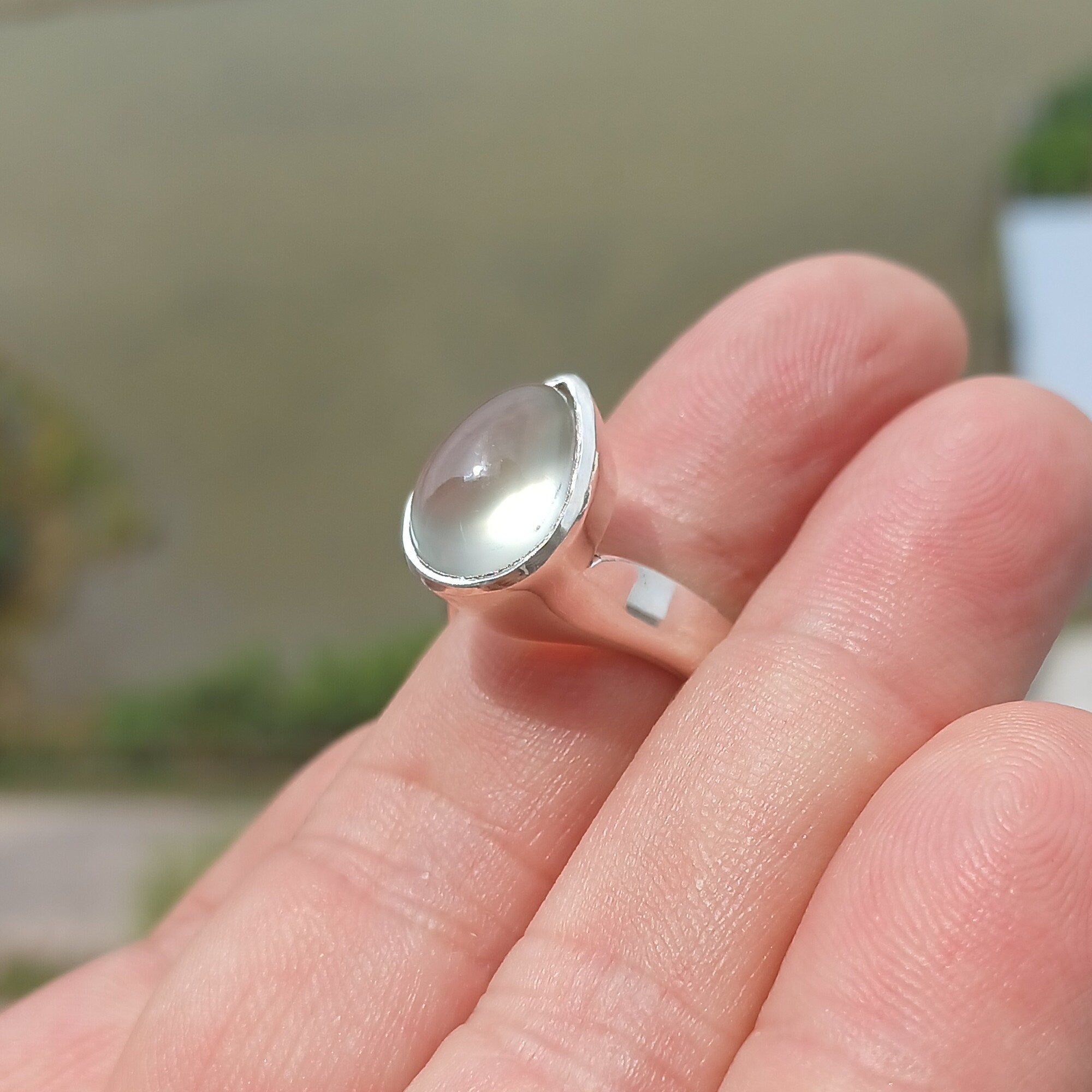 Natural Prehnite Ring featuring a pear-shaped green gemstone set in a polished sterling silver band, showcasing elegance and quality craftsmanship.