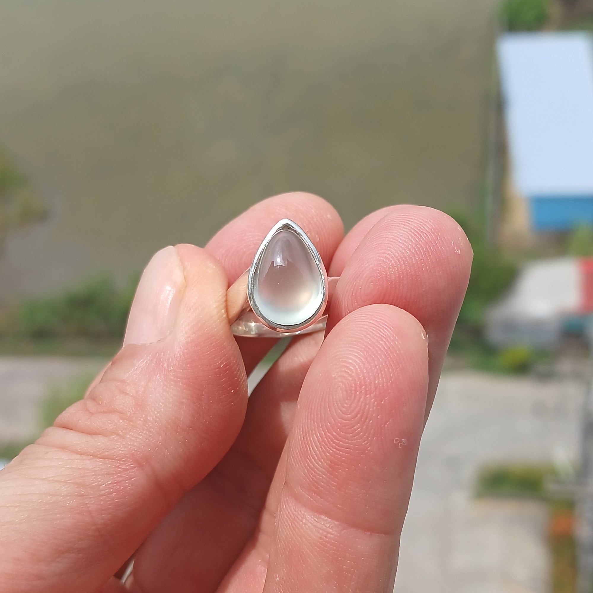 Natural Prehnite Ring featuring a pear-shaped green gemstone set in a polished sterling silver band, showcasing elegance and quality craftsmanship.