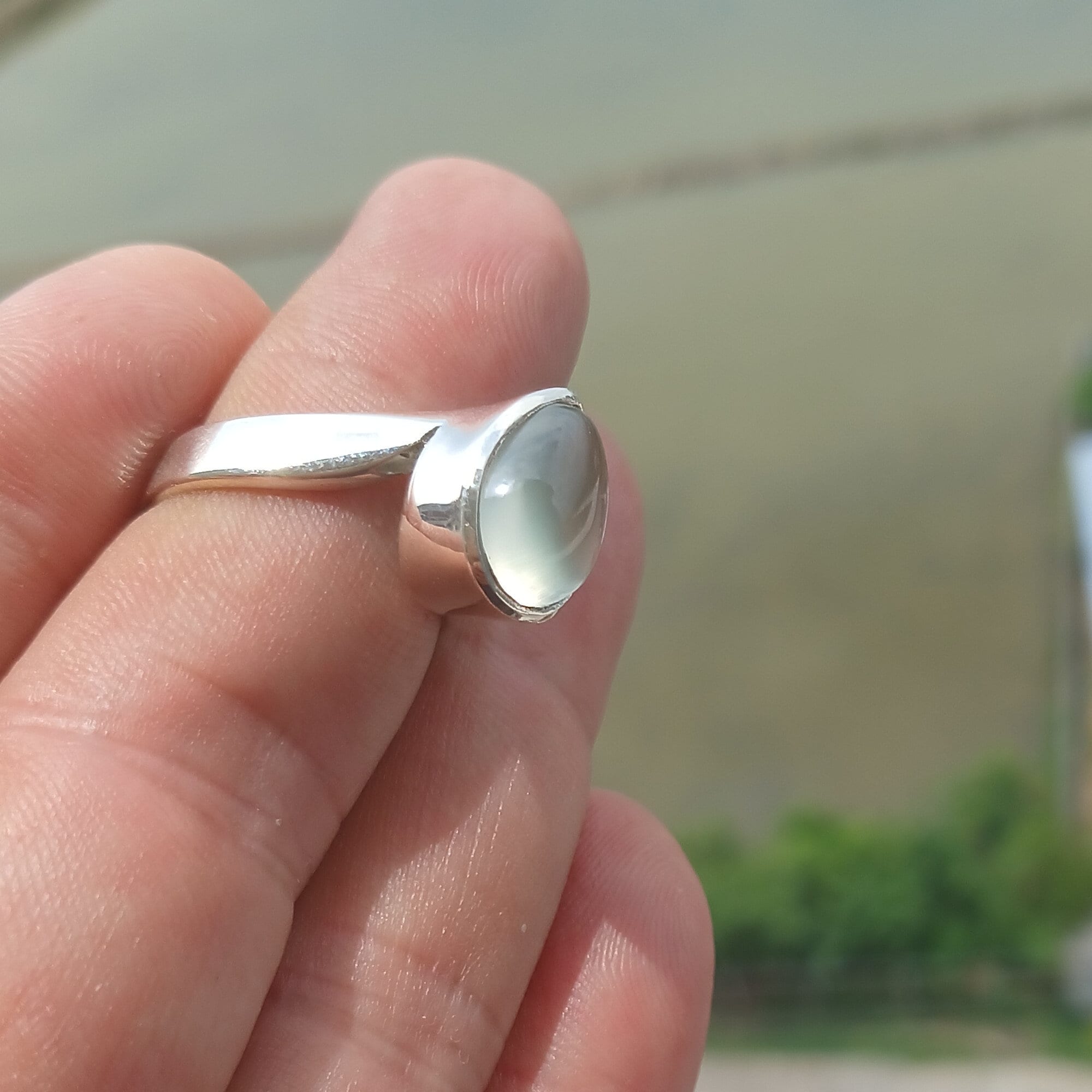 Natural Prehnite Ring featuring a pear-shaped green gemstone set in a polished sterling silver band, showcasing elegance and quality craftsmanship.