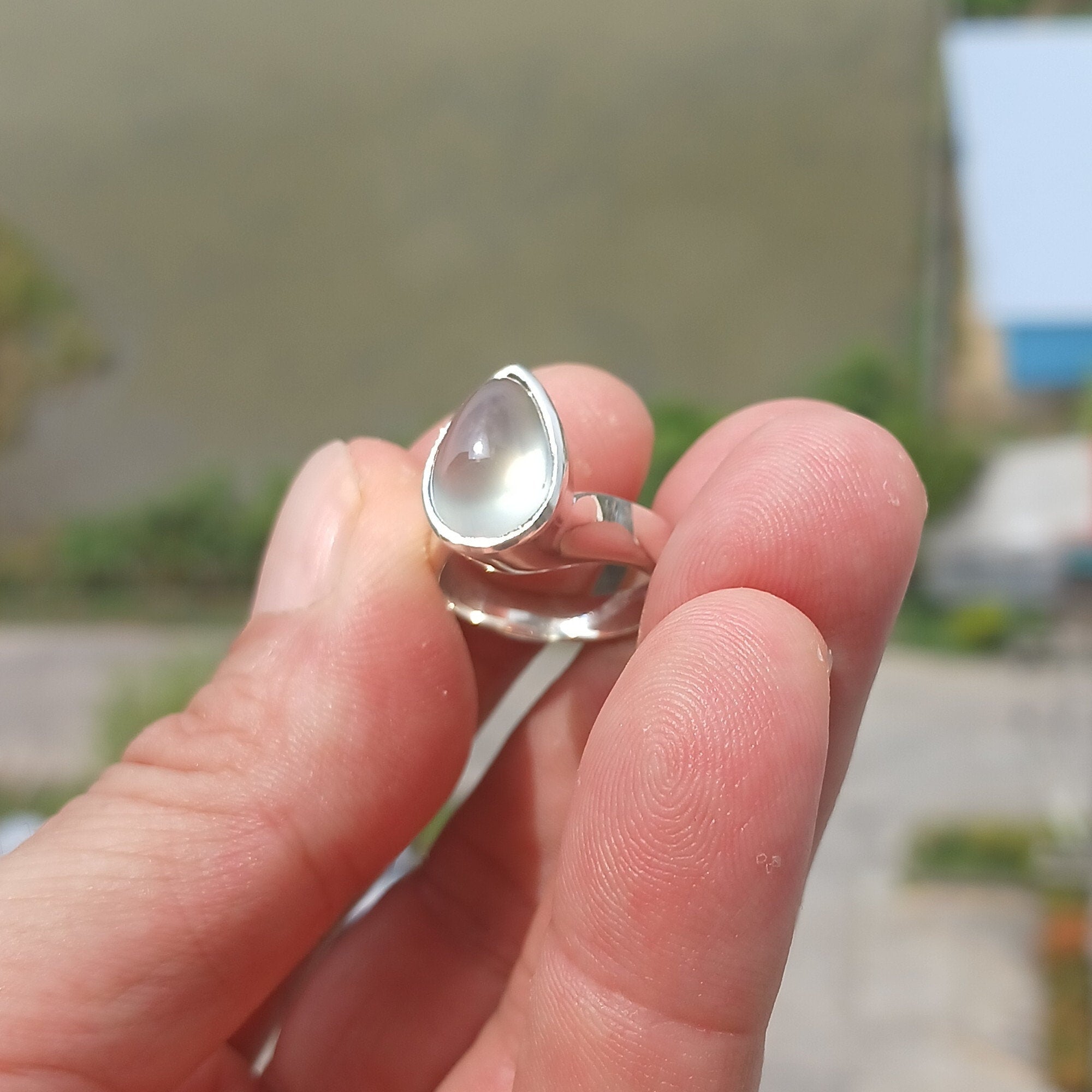 Natural Prehnite Ring featuring a pear-shaped green gemstone set in a polished sterling silver band, showcasing elegance and quality craftsmanship.