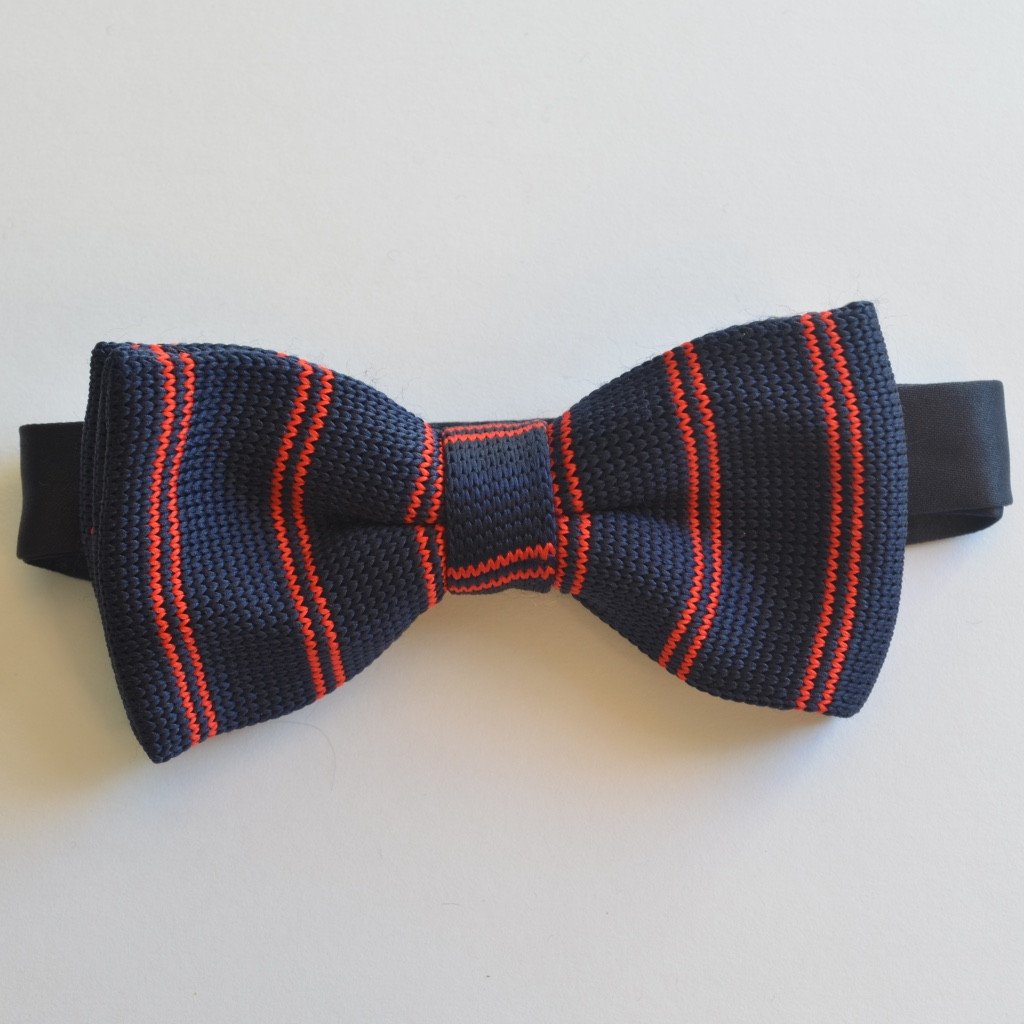 Navy blue and red striped knitted bow tie, pre-tied and adjustable, showcasing elegant craftsmanship.