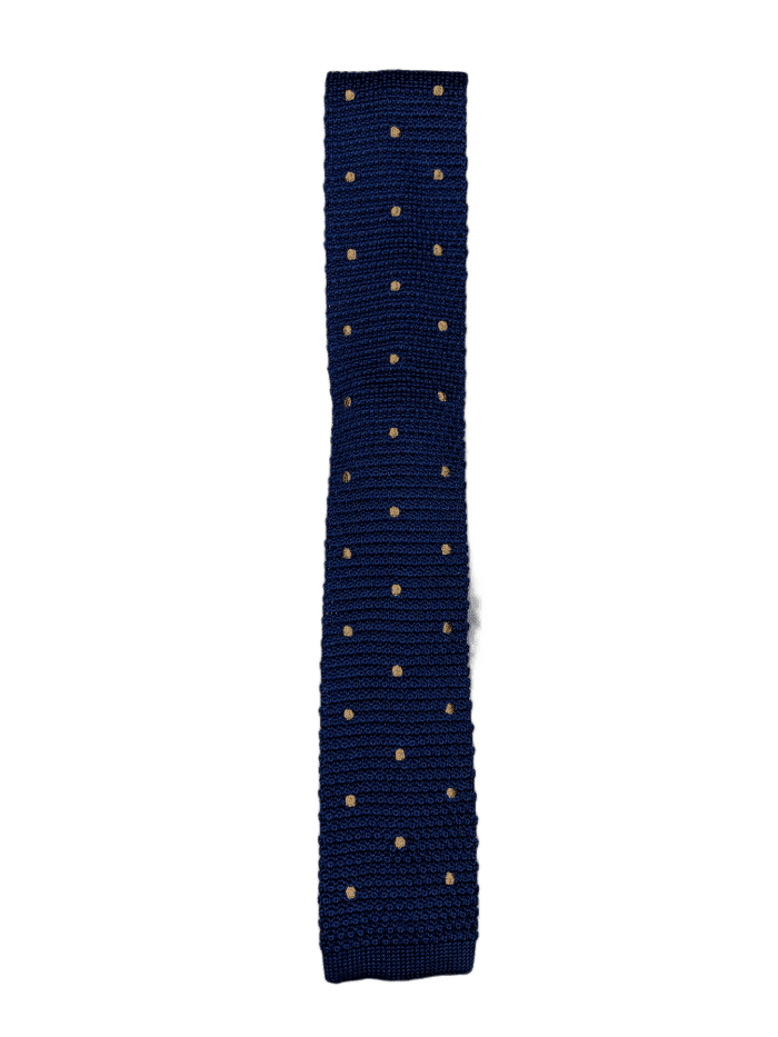 Navy blue knitted tie with gold polka dots, showcasing a square end design and luxurious silk material.