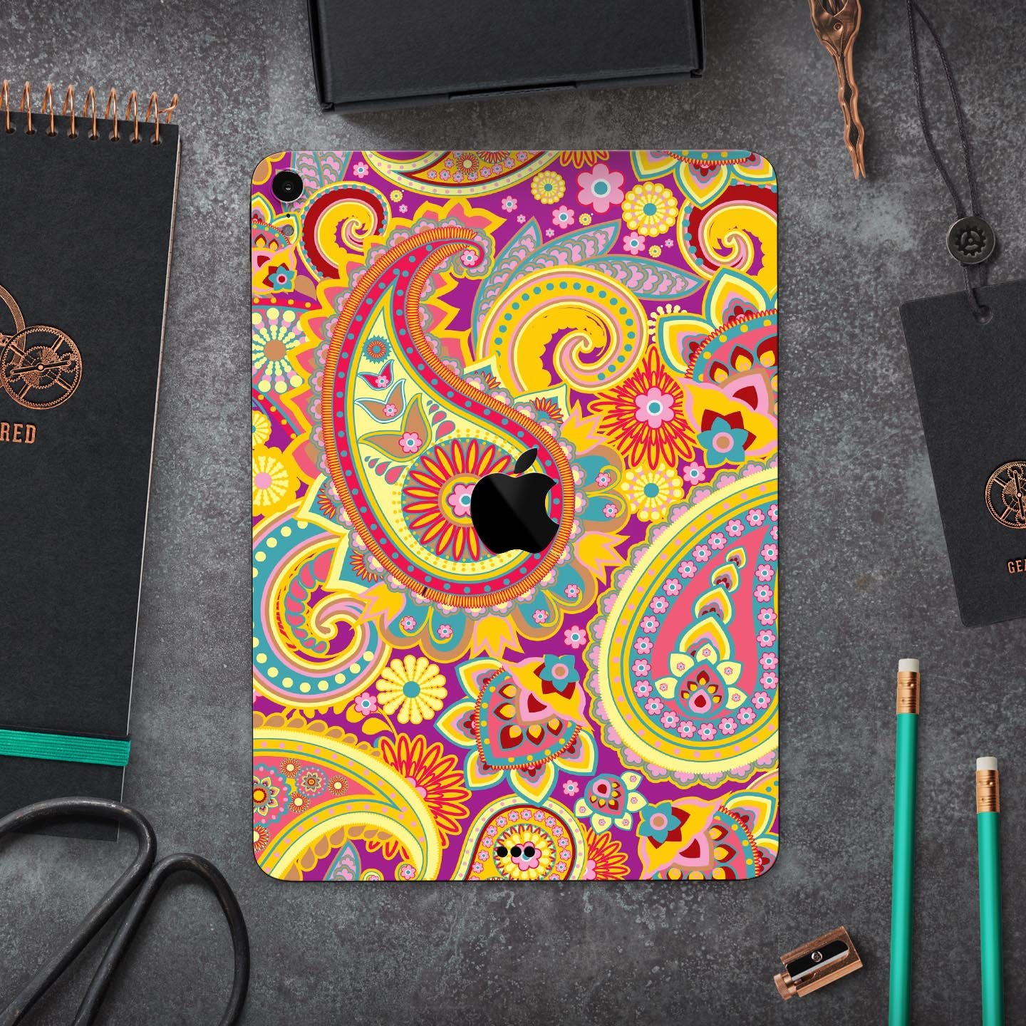 Neon orange paisley pattern full body skin decal for Apple iPad, showcasing vibrant colors and intricate design.