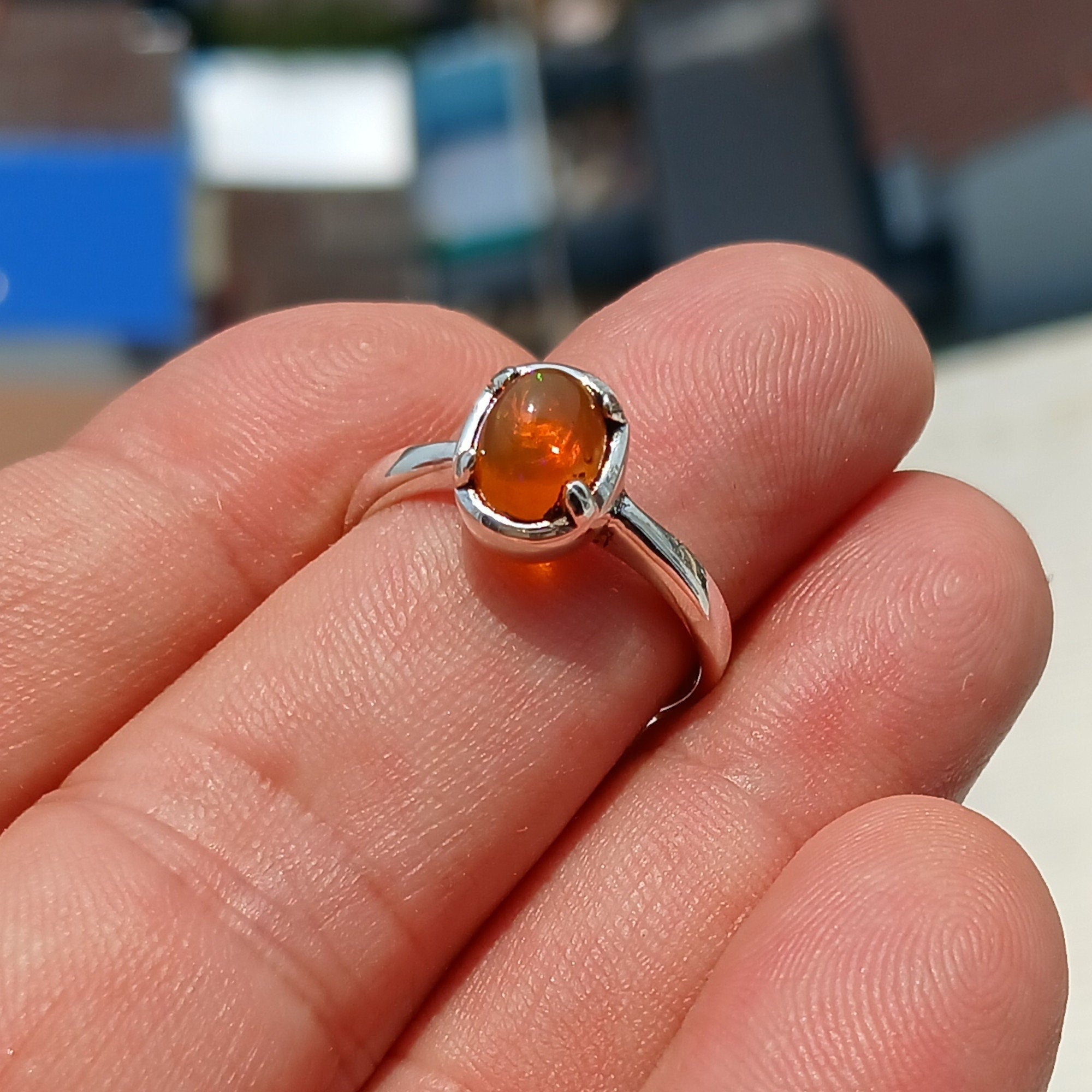 A stunning handcrafted sterling silver Opal Ring featuring an oval-shaped opal with vibrant colors, elegantly polished for a sophisticated look.