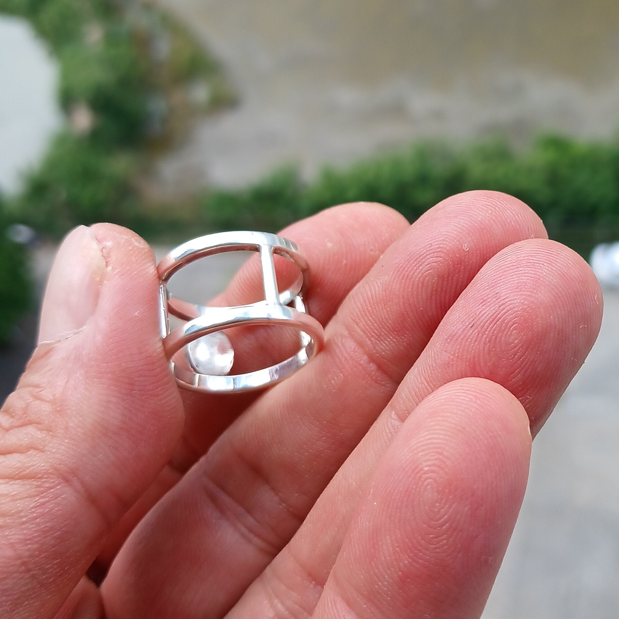 A handcrafted sterling silver solitaire ring featuring a vibrant oval opal, showcasing its unique colors and patterns.