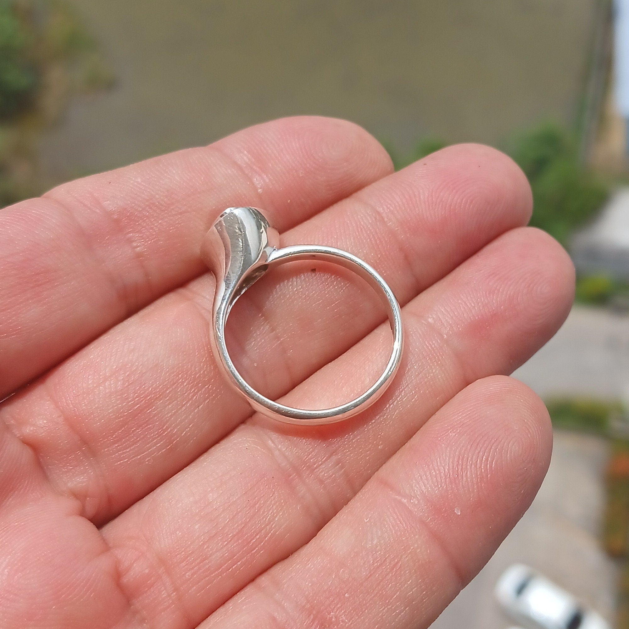 A stunning triangle-shaped Opal Ring made of high-quality sterling silver, showcasing a vibrant play of colors.