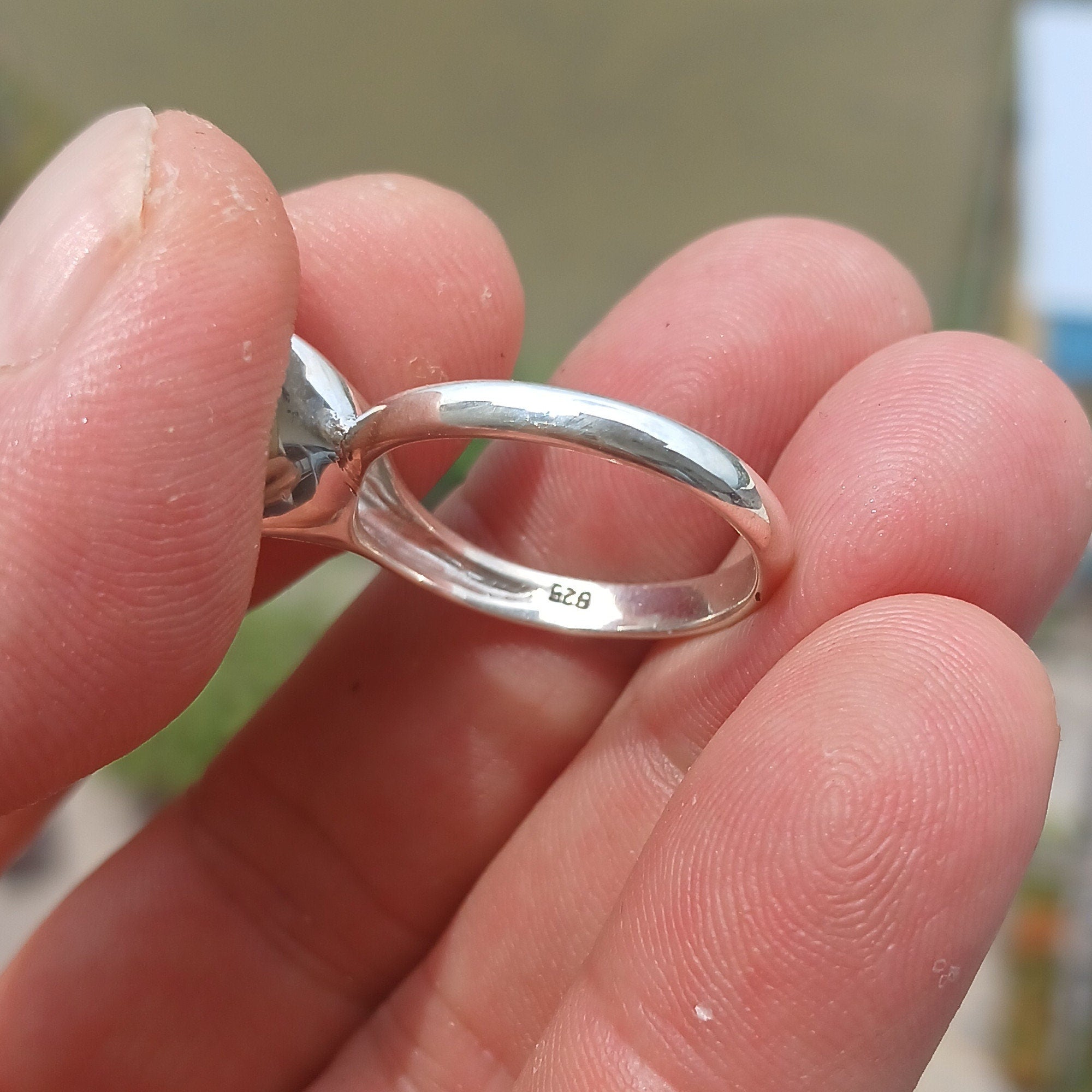 A stunning triangle-shaped Opal Ring made of high-quality sterling silver, showcasing a vibrant play of colors.