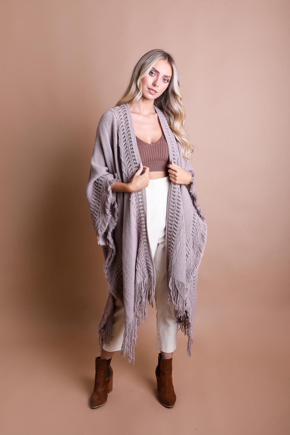 Open Work Frayed Bohemian Ruana showcasing a stylish knitted design with frayed edges, perfect for layering.