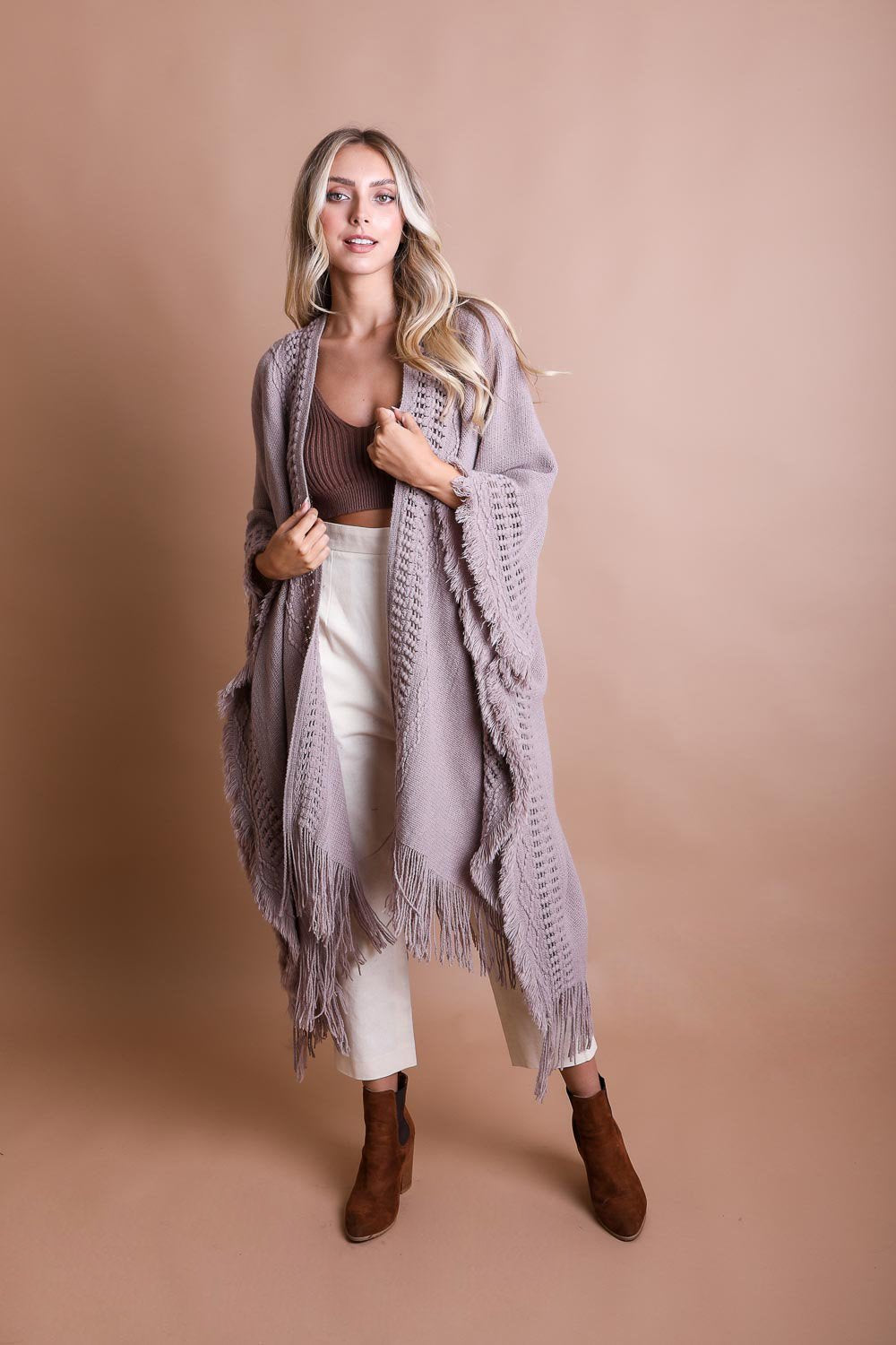 Open Work Frayed Bohemian Ruana showcasing a stylish knitted design with frayed edges, perfect for layering.