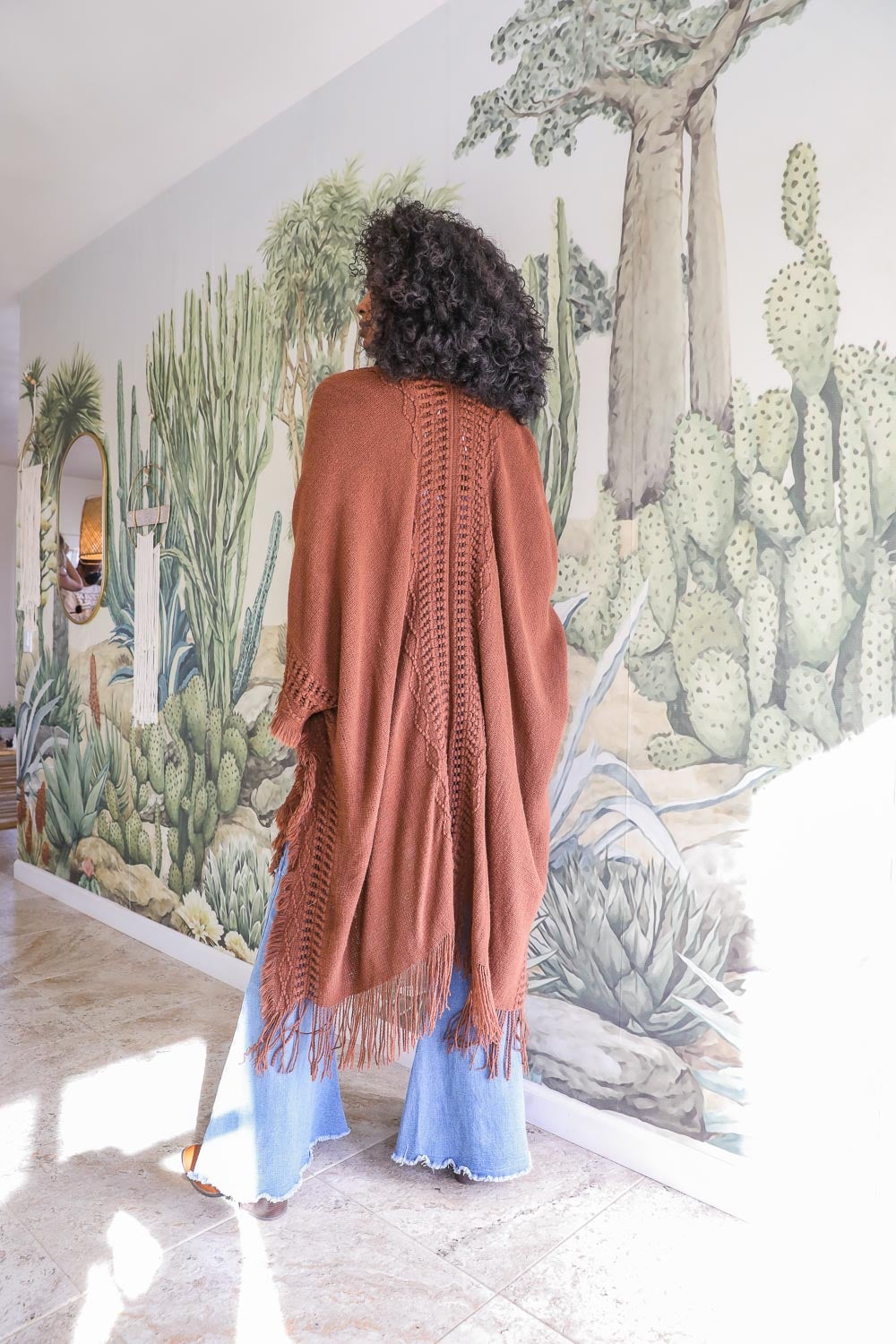 Open Work Frayed Bohemian Ruana showcasing a stylish knitted design with frayed edges, perfect for layering.