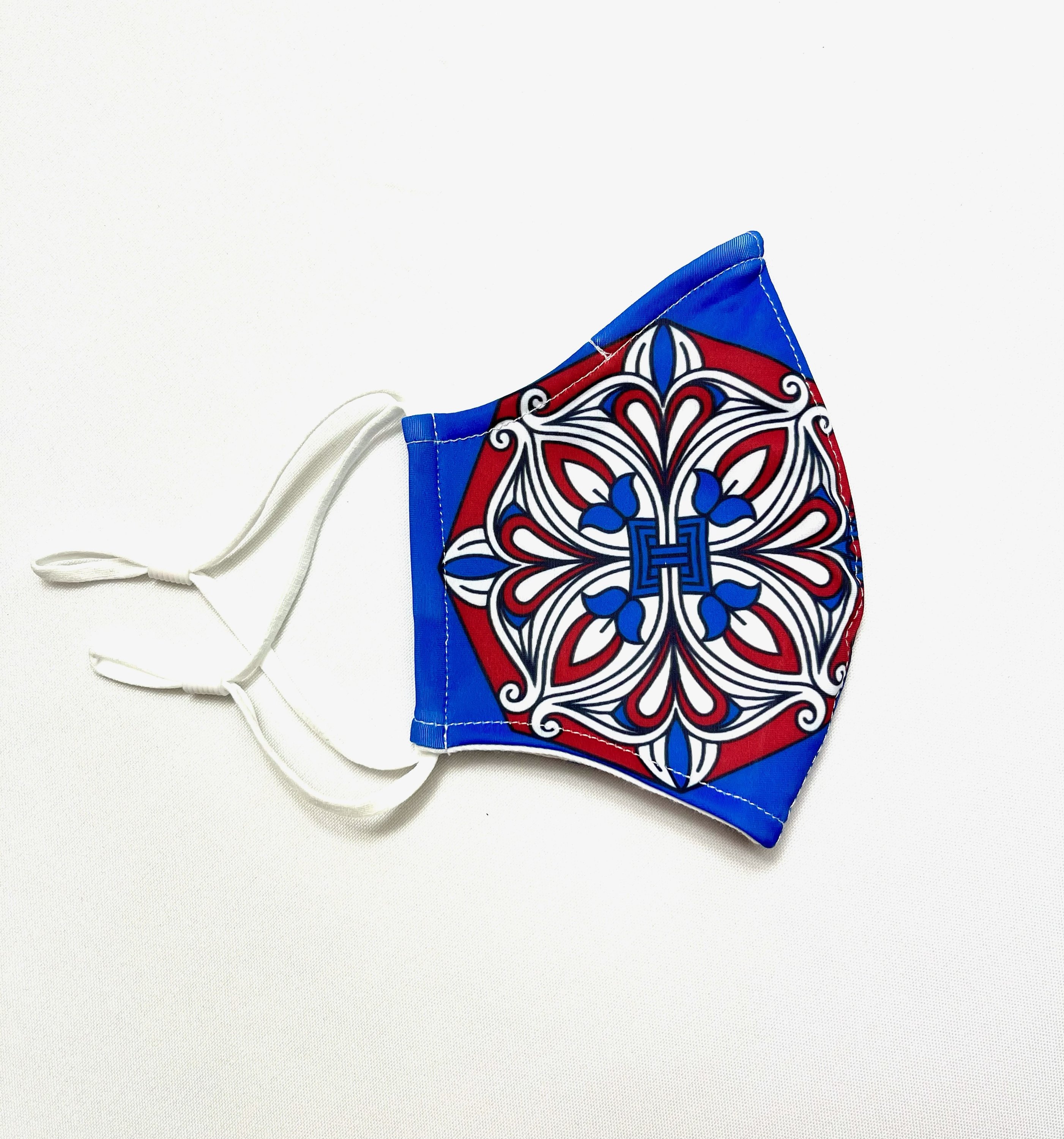 Ornament Face Mask featuring a stylish design with adjustable ear loops and contoured nose wire, made from lightweight polyester fabric.