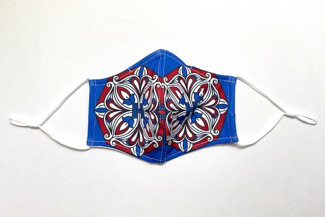 Ornament Face Mask featuring a stylish design with adjustable ear loops and contoured nose wire, made from lightweight polyester fabric.