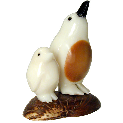 Hand-carved Penguin with Baby figurine made from tagua nuts, showcasing intricate details and natural colors.