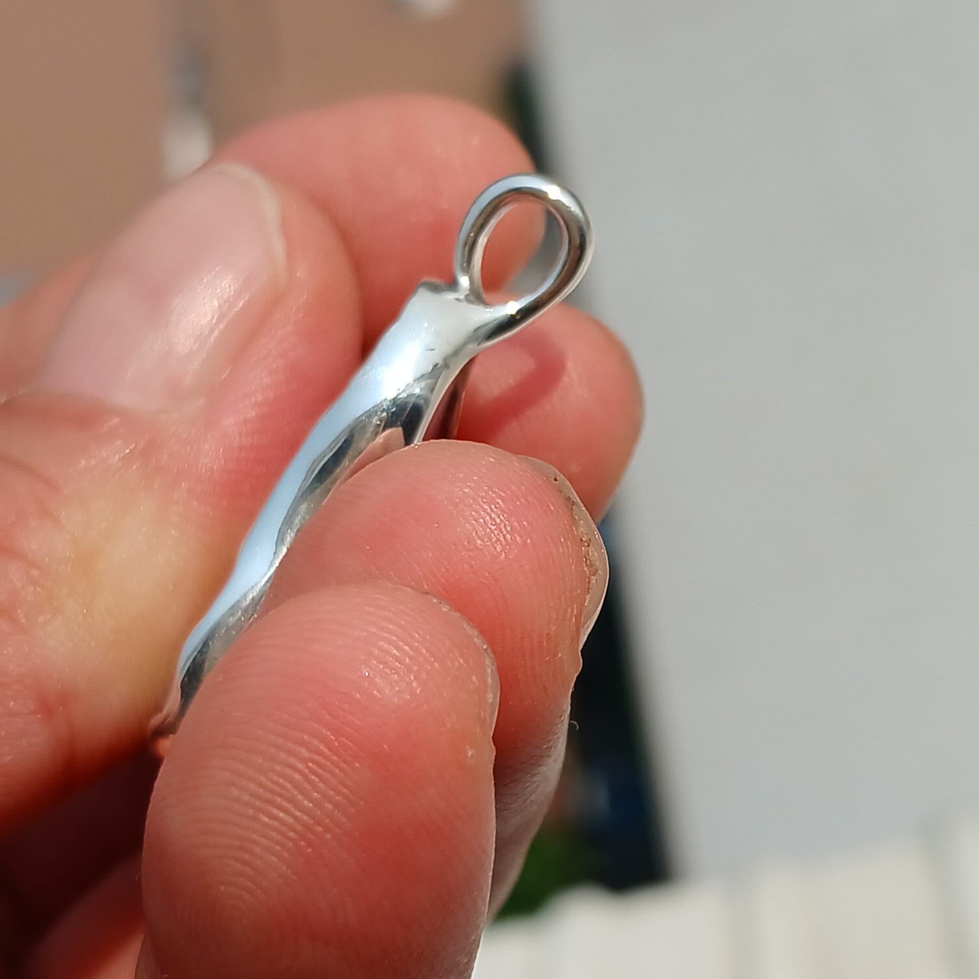 A stunning pink agate pendant in a pear shape, set in high-quality sterling silver, showcasing intricate artwork and natural beauty.