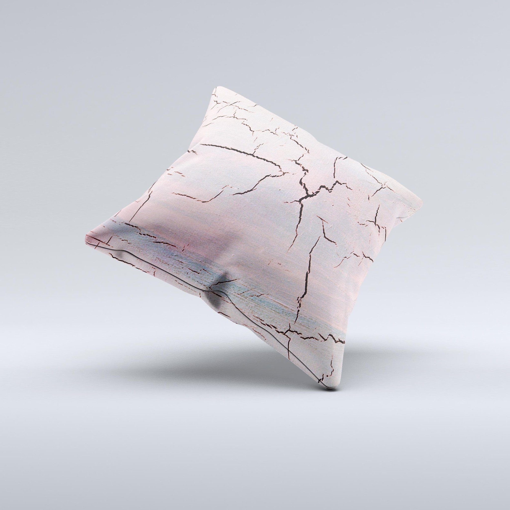 Pink decorative throw pillow with a cracked surface texture, handcrafted in Virginia, showcasing unique design and high-quality fabric.