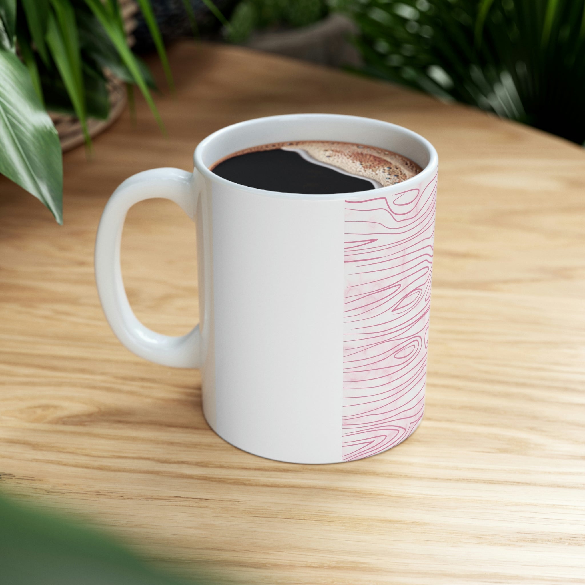 A stylish pink ceramic mug featuring a unique line art sketch print, perfect for coffee or tea.