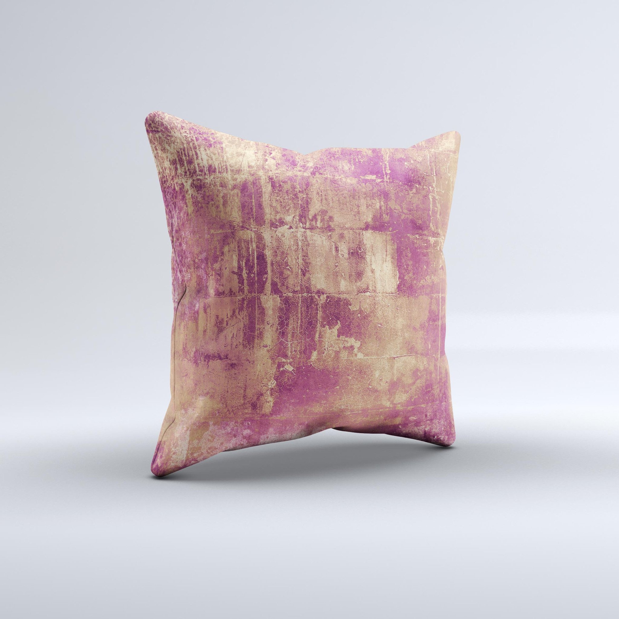 A vibrant pink paint splattered decorative throw pillow featuring a brick wall design, handcrafted in Virginia.