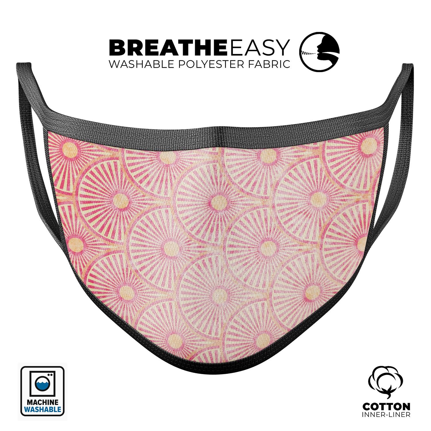 A vibrant pink face mask featuring semi-circles and yellow polka dots, made in the USA, showcasing adjustable ear loops for a custom fit.