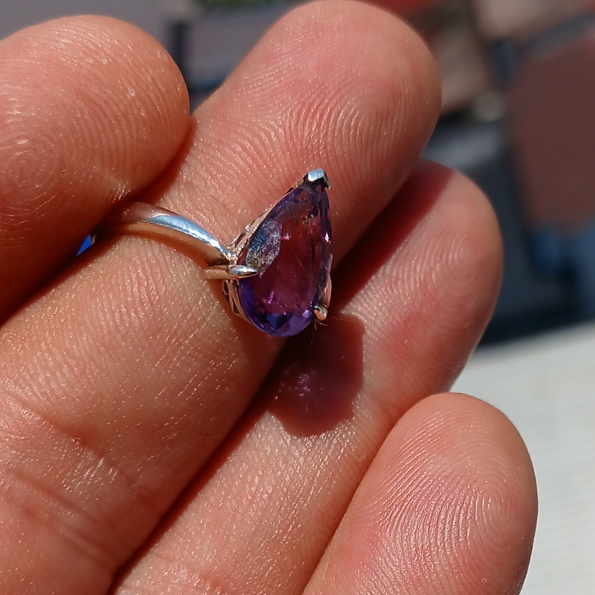 A beautiful purple amethyst ring in sterling silver, featuring a pear-shaped gemstone with a polished finish, showcasing elegance and style.