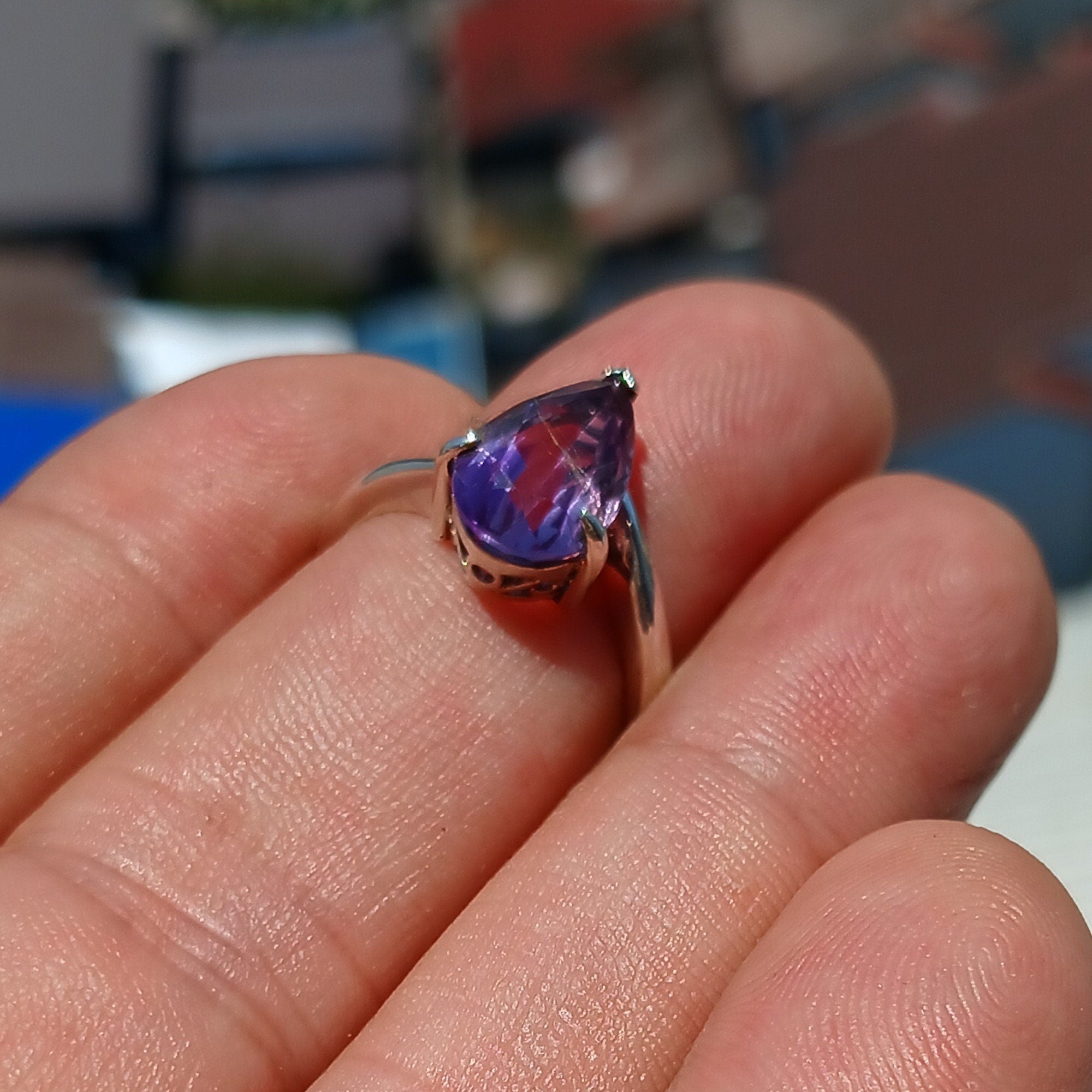 A beautiful purple amethyst ring in sterling silver, featuring a pear-shaped gemstone with a polished finish, showcasing elegance and style.