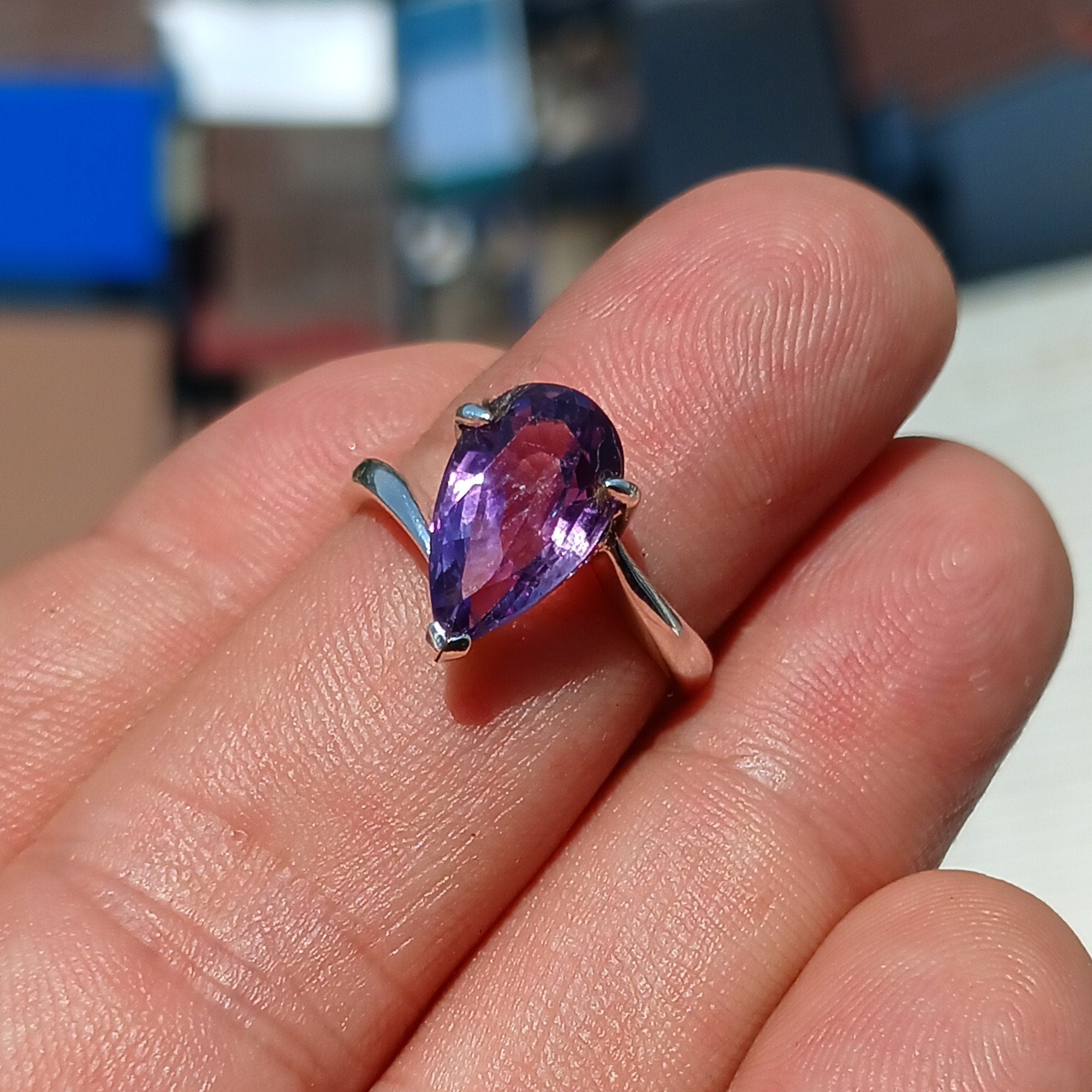A beautiful purple amethyst ring in sterling silver, featuring a pear-shaped gemstone with a polished finish, showcasing elegance and style.