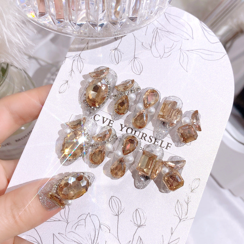 A box set containing 24 sparkling gem fake nails with nail care tools, showcasing elegance and style.