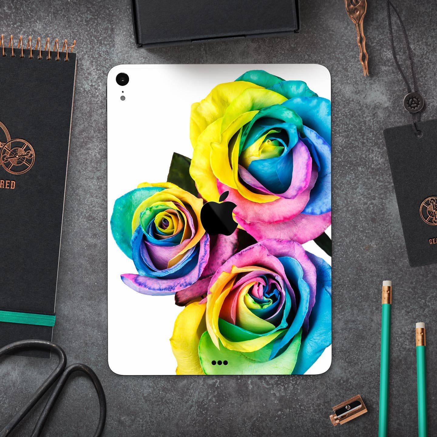 Colorful Rainbow Dyed Roses skin decal for Apple iPad Pro, showcasing vibrant floral design and ultra-thin protection.