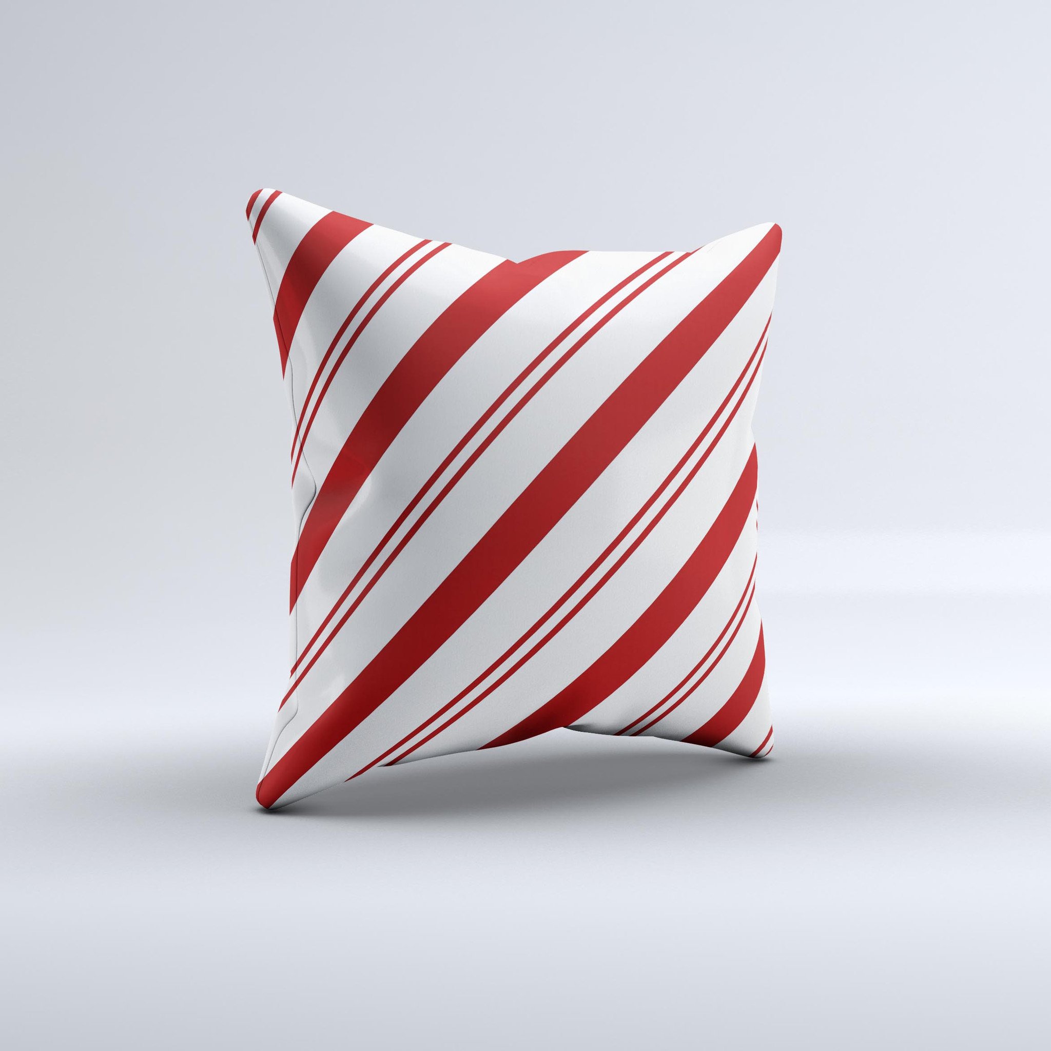 Red and white decorative throw pillow with slanted vector stripes, showcasing a unique handmade design.
