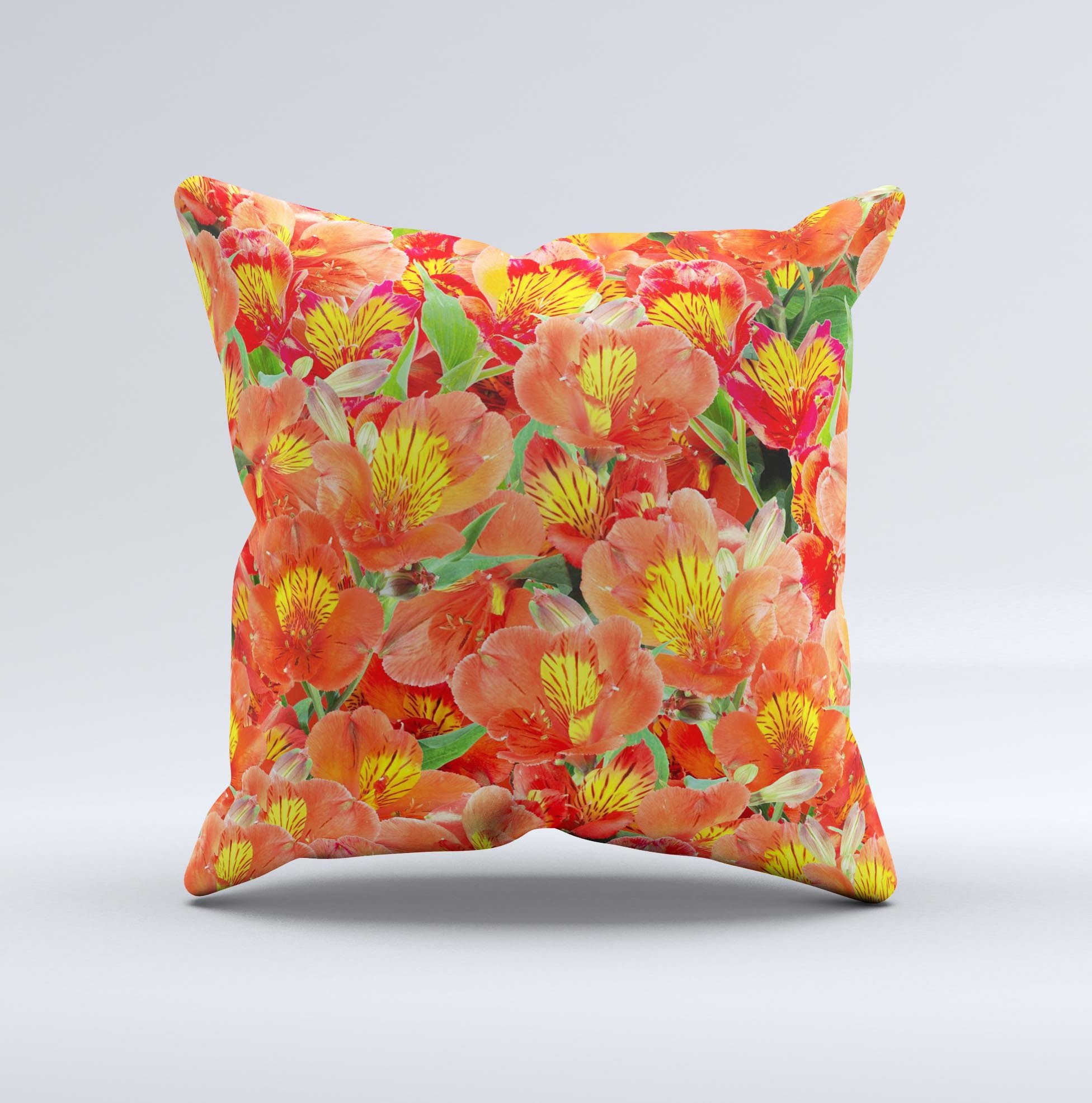 A vibrant decorative throw pillow featuring red and yellow watercolor flowers on a soft fabric, handcrafted in Virginia.