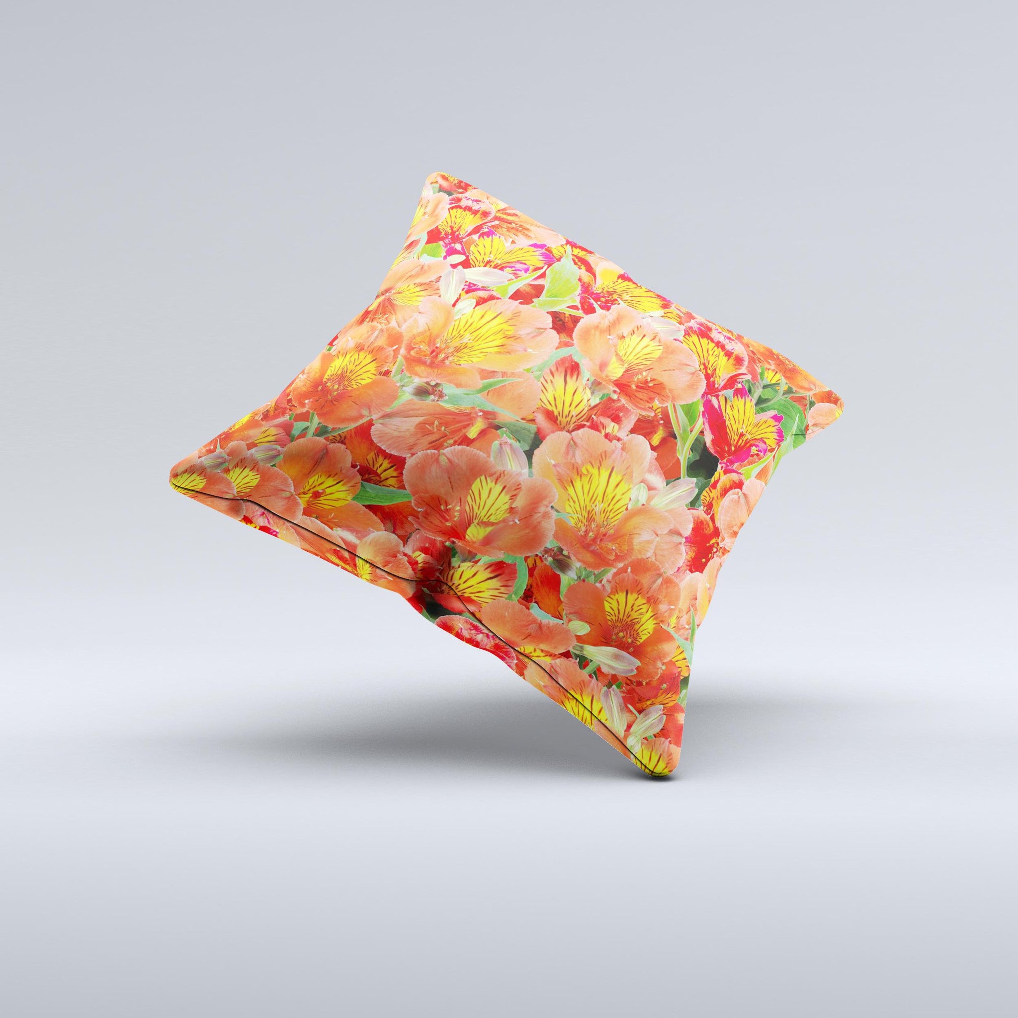 A vibrant decorative throw pillow featuring red and yellow watercolor flowers on a soft fabric, handcrafted in Virginia.