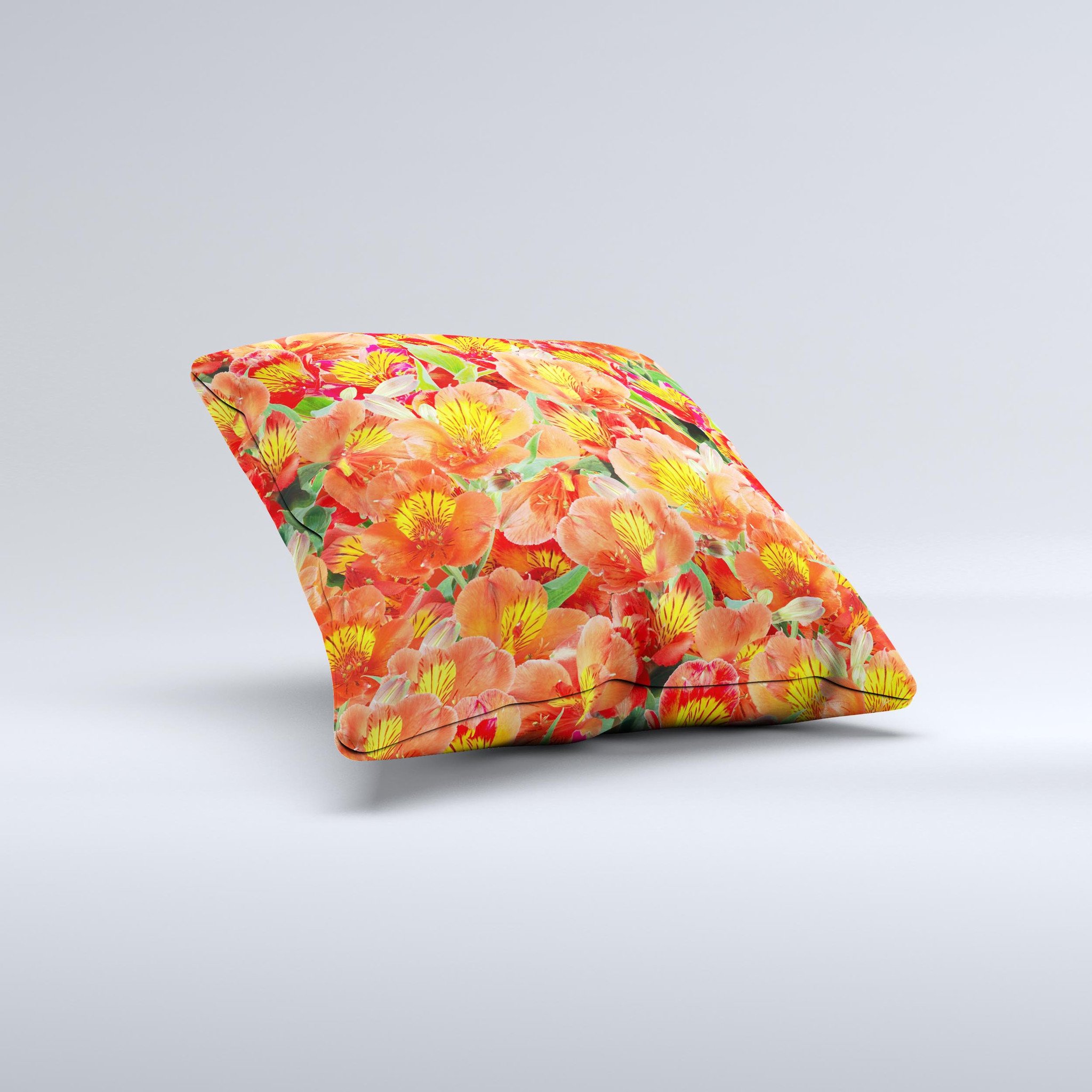 A vibrant decorative throw pillow featuring red and yellow watercolor flowers on a soft fabric, handcrafted in Virginia.