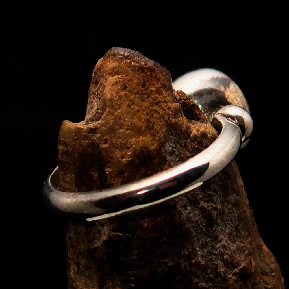 A stunning Red Garnet Ring featuring an oval-shaped red Garnet cabochon set in polished Sterling Silver, showcasing its elegant design.