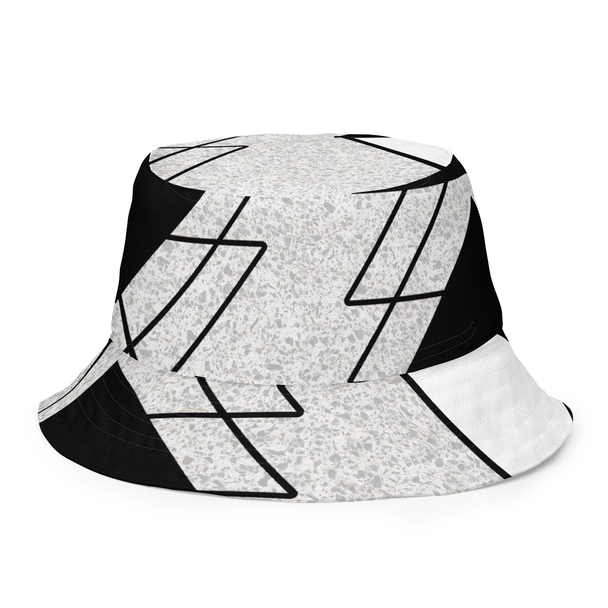 Reversible bucket hat featuring black and white ash grey triangular colorblock design, showcasing its stylish and versatile look.