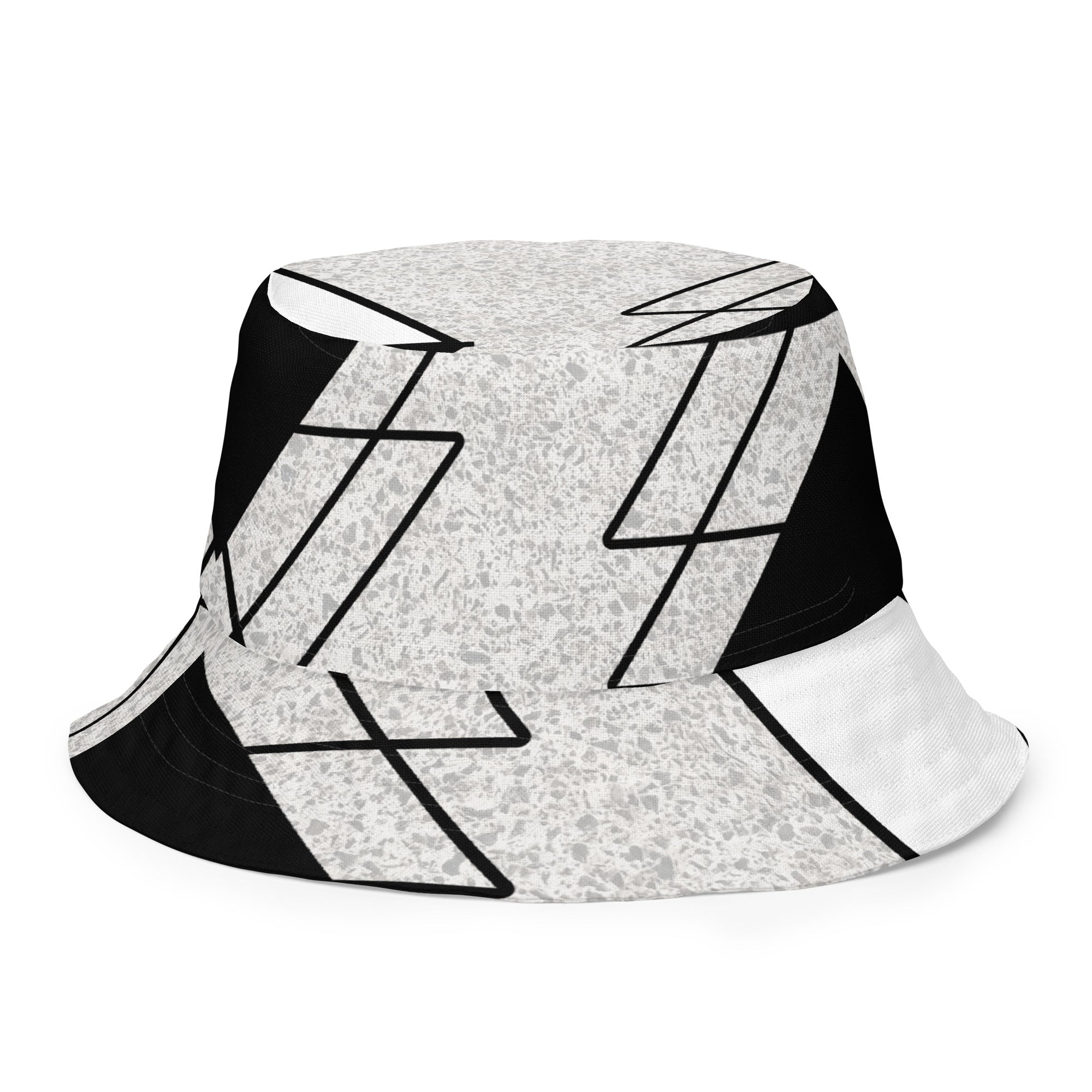 Reversible bucket hat featuring black and white ash grey triangular colorblock design, showcasing its stylish and versatile look.