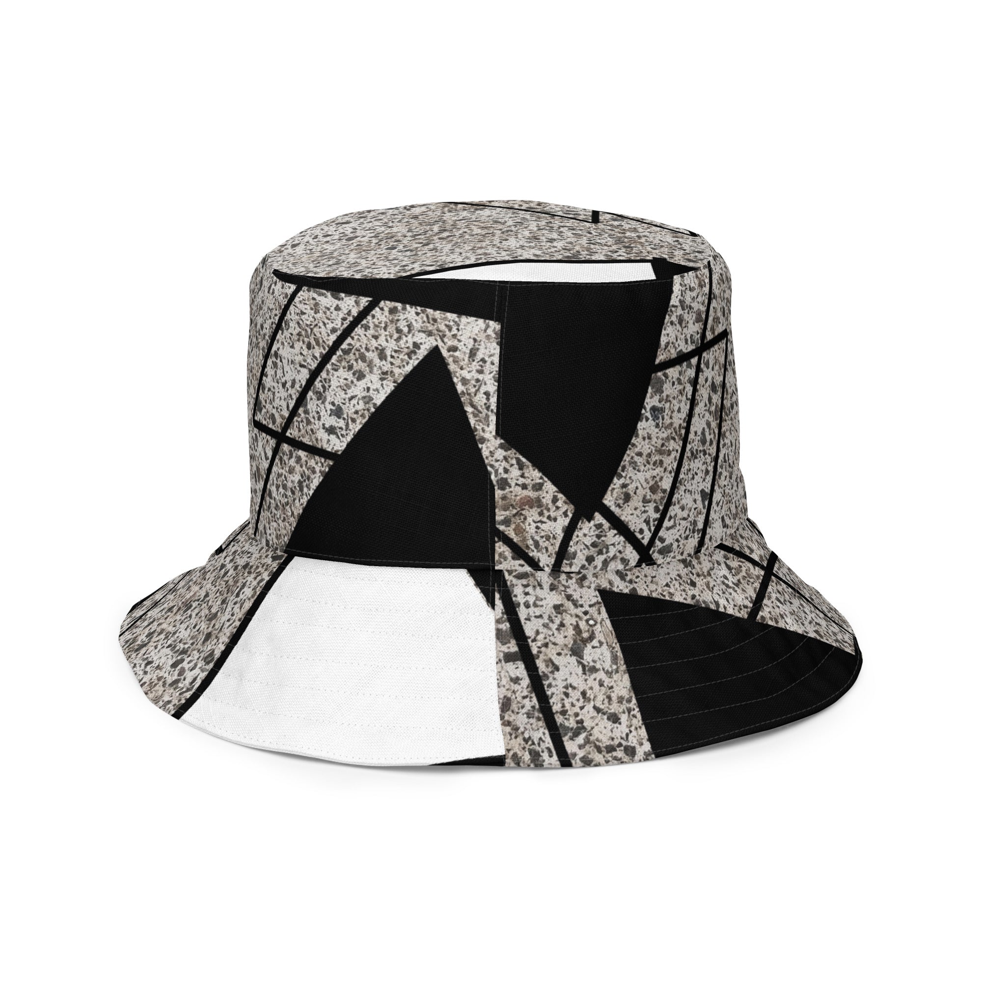 Reversible bucket hat featuring black and white triangular colorblock design, perfect for streetwear fashion.