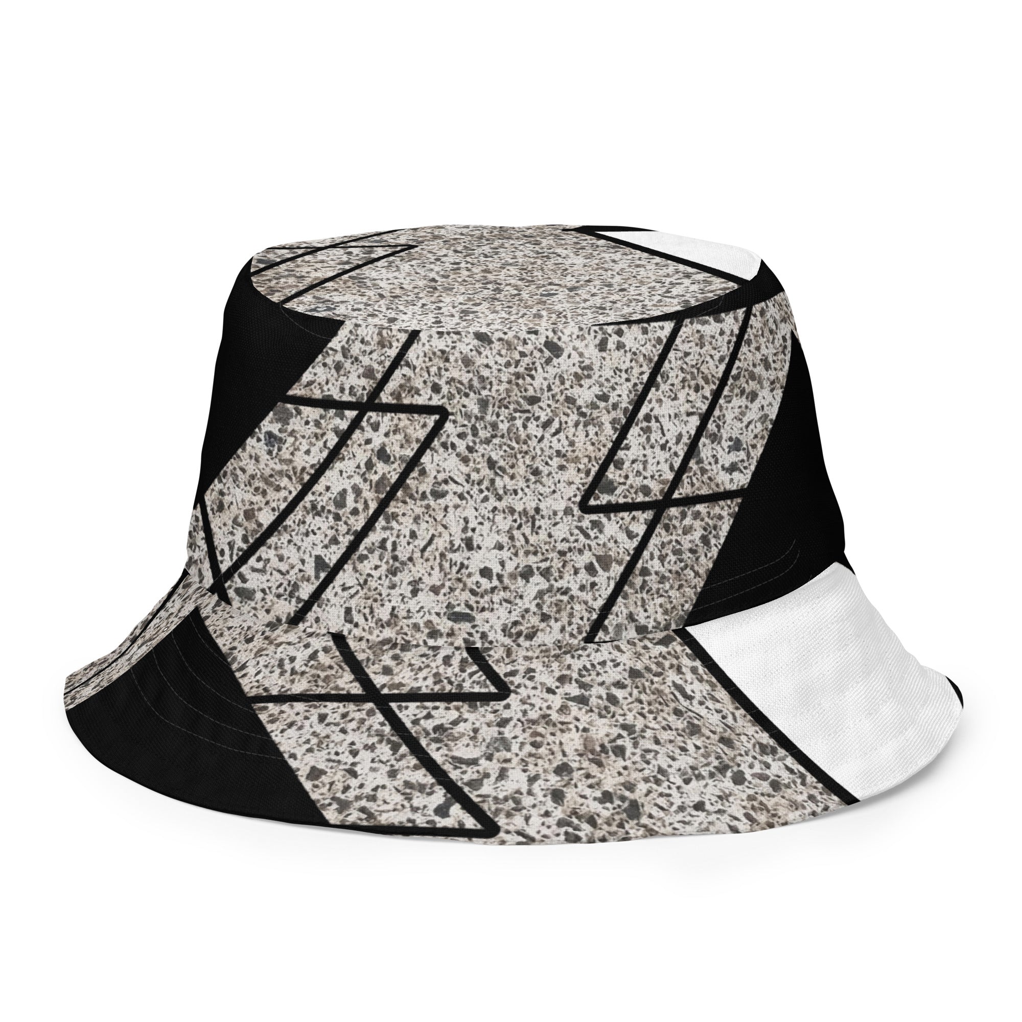Reversible bucket hat featuring black and white triangular colorblock design, perfect for streetwear fashion.